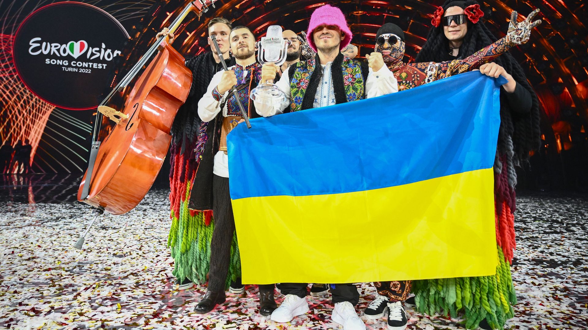 Members of the band "Kalush Orchestra" pose onstage with the winner's trophy and Ukraine's flags after winning on behalf of Ukraine the Eurovision Song contest 2022 on May 14, 2022 in Turin.