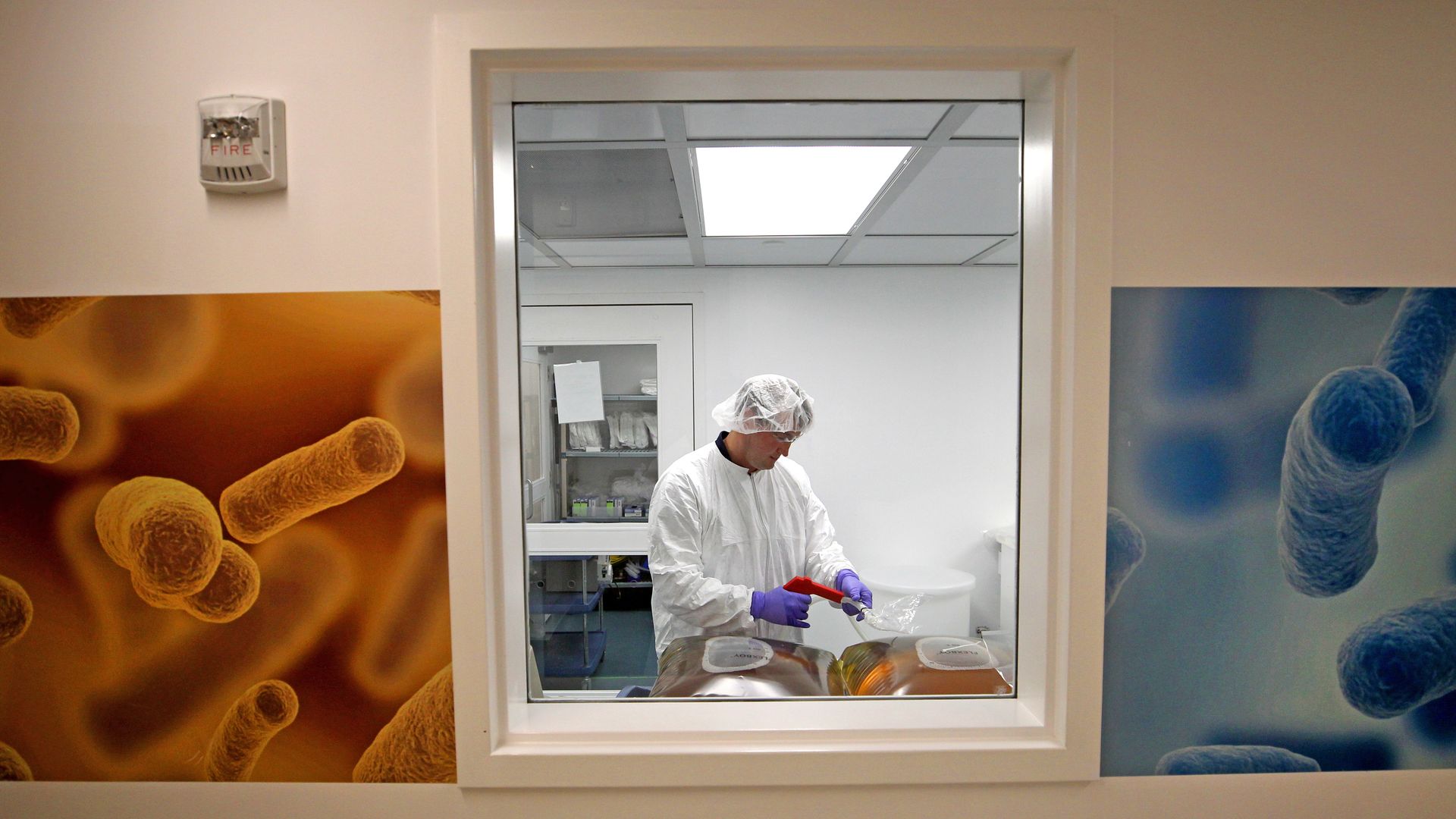 A technician in a pharmaceutical manufacturing facility