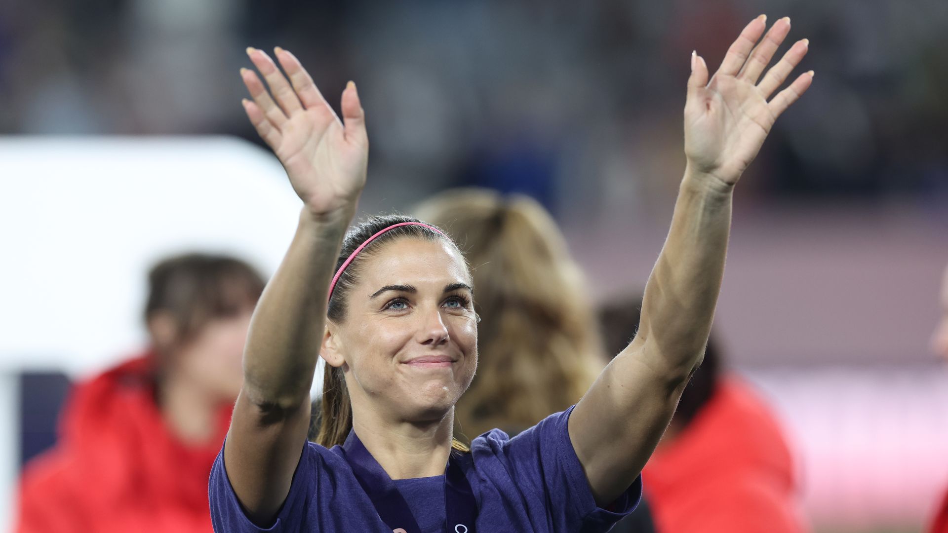 Alex Morgan waives to fans