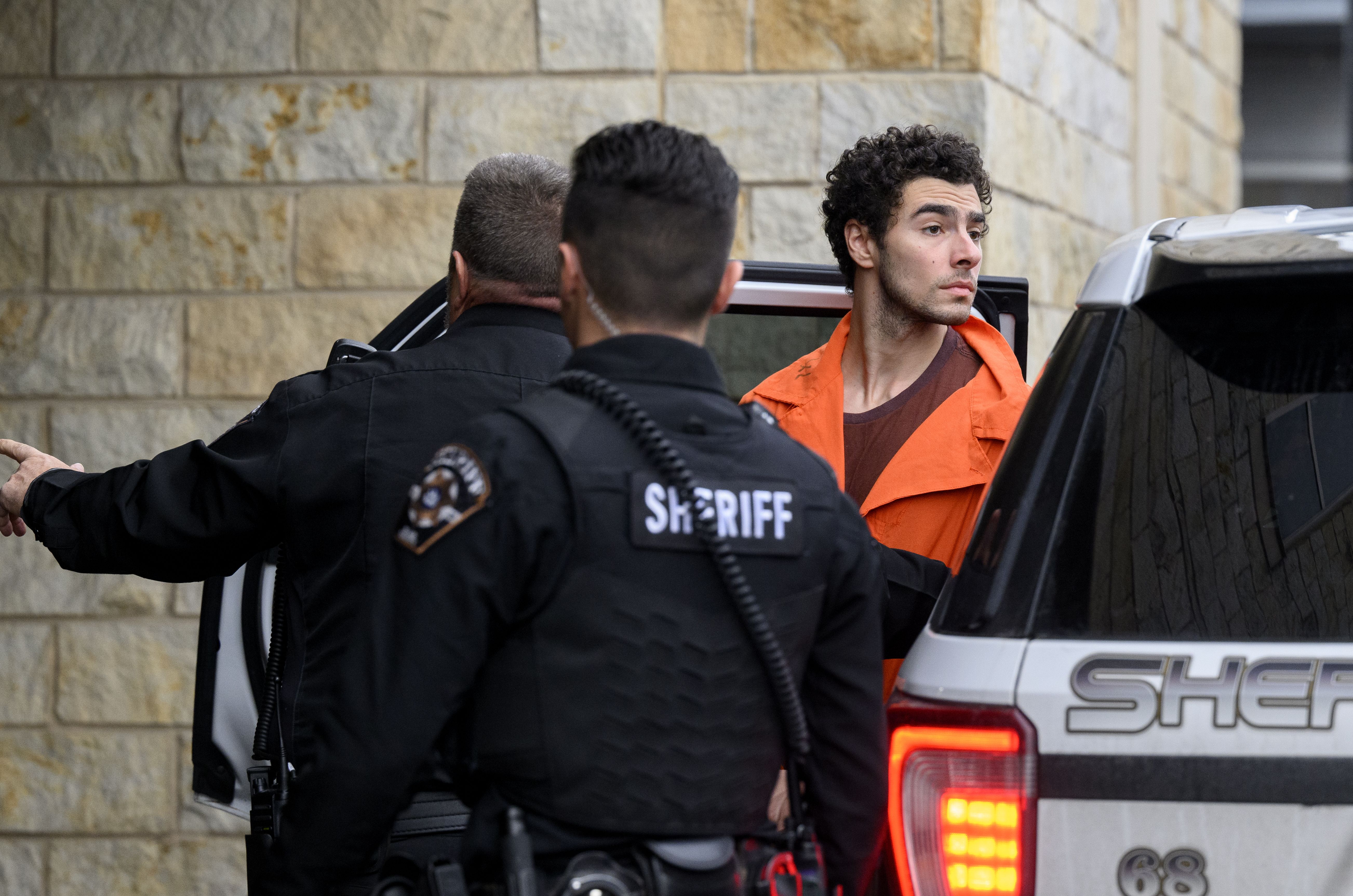 Suspected shooter Luigi Mangione is led into the Blair County Courthouse for an extradition hearing December 10, 2024 in Hollidaysburg, Pennsylvania. Mangione has been arraigned on weapons and false identification charges related to the fatal shooting of United Healthcare CEO Brian Thompson in New Y