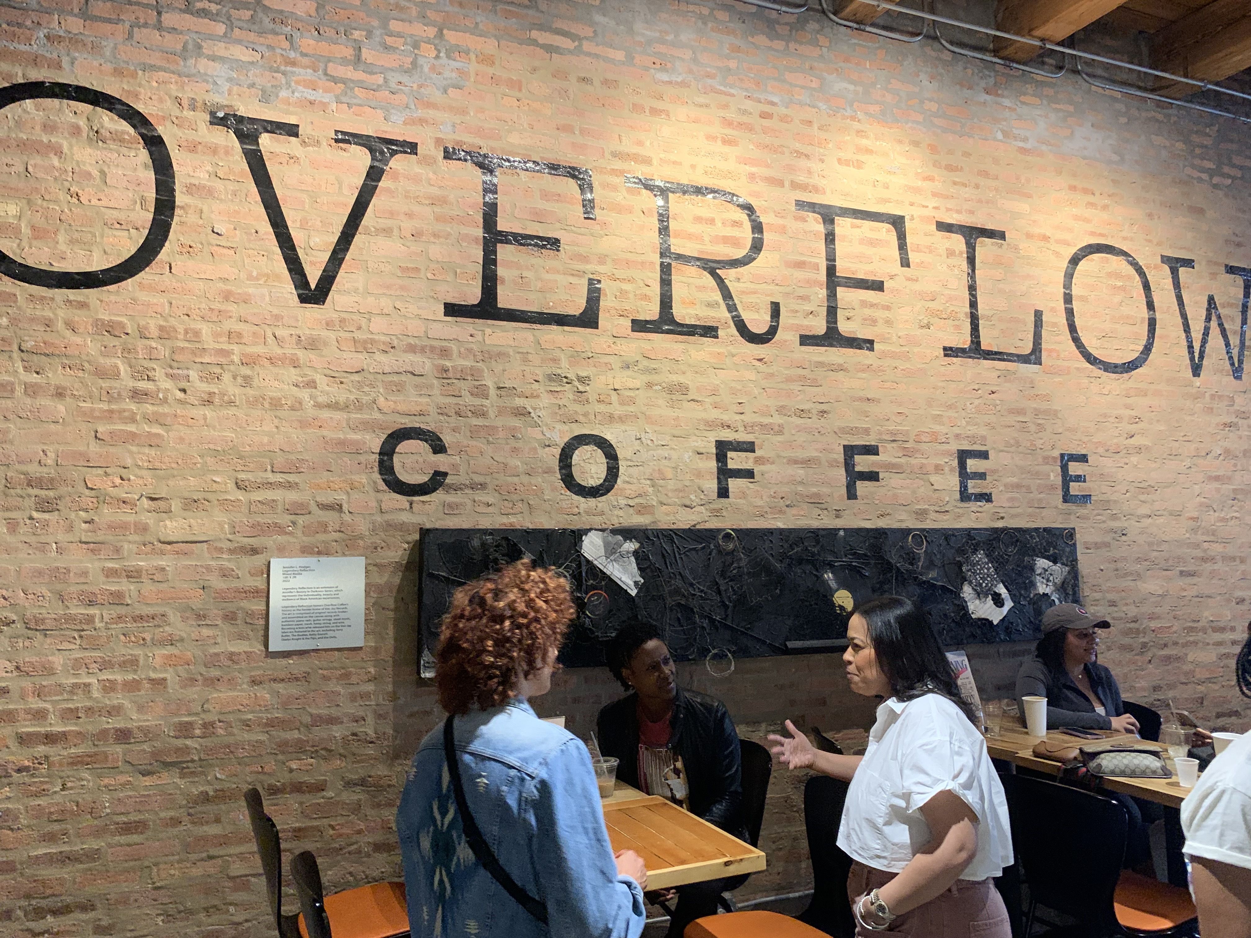Photo of a sign that says OVERFLOW COFFEE. 