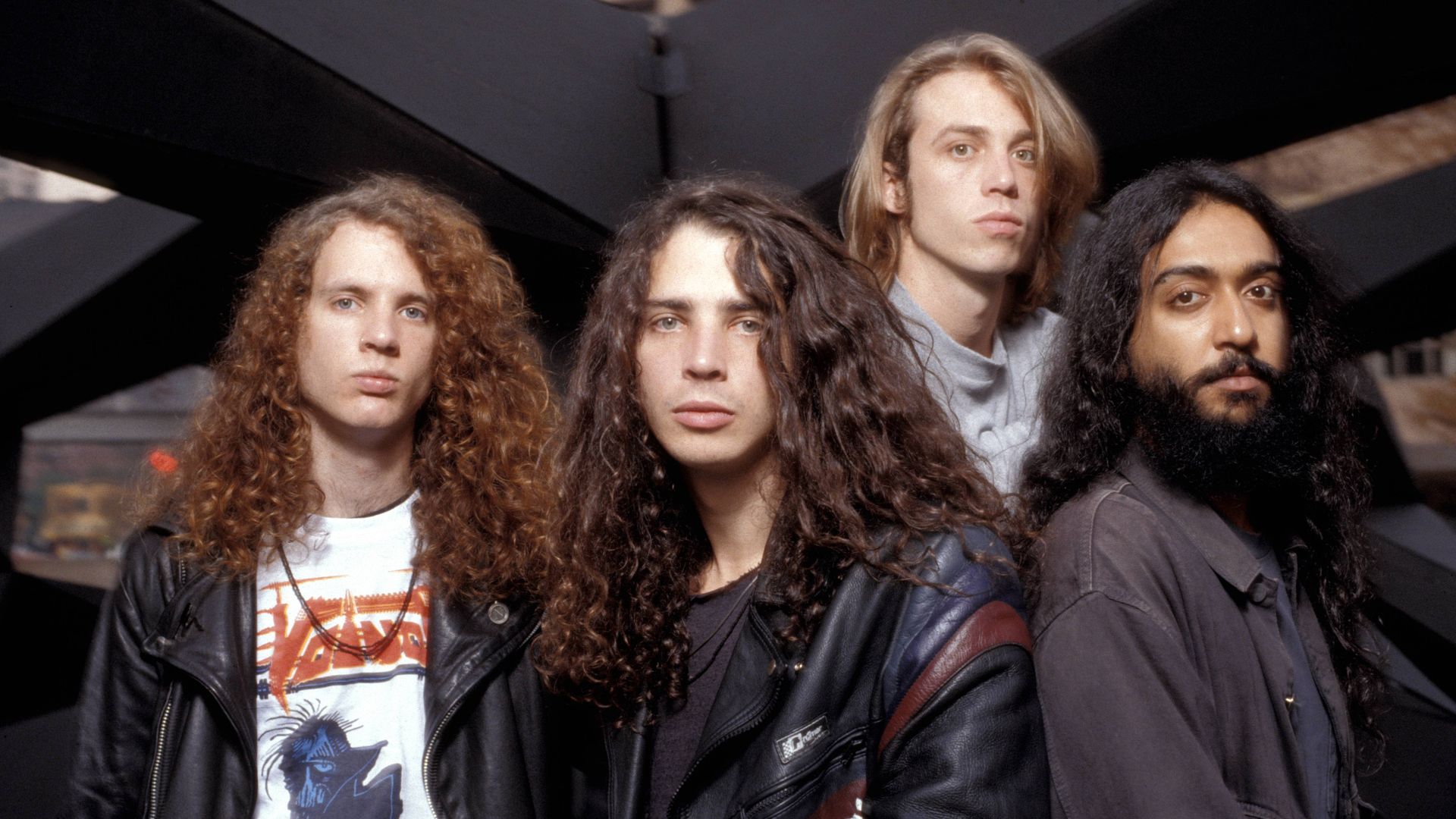 Four members of Soundgarden are shown looking directly at the camera.