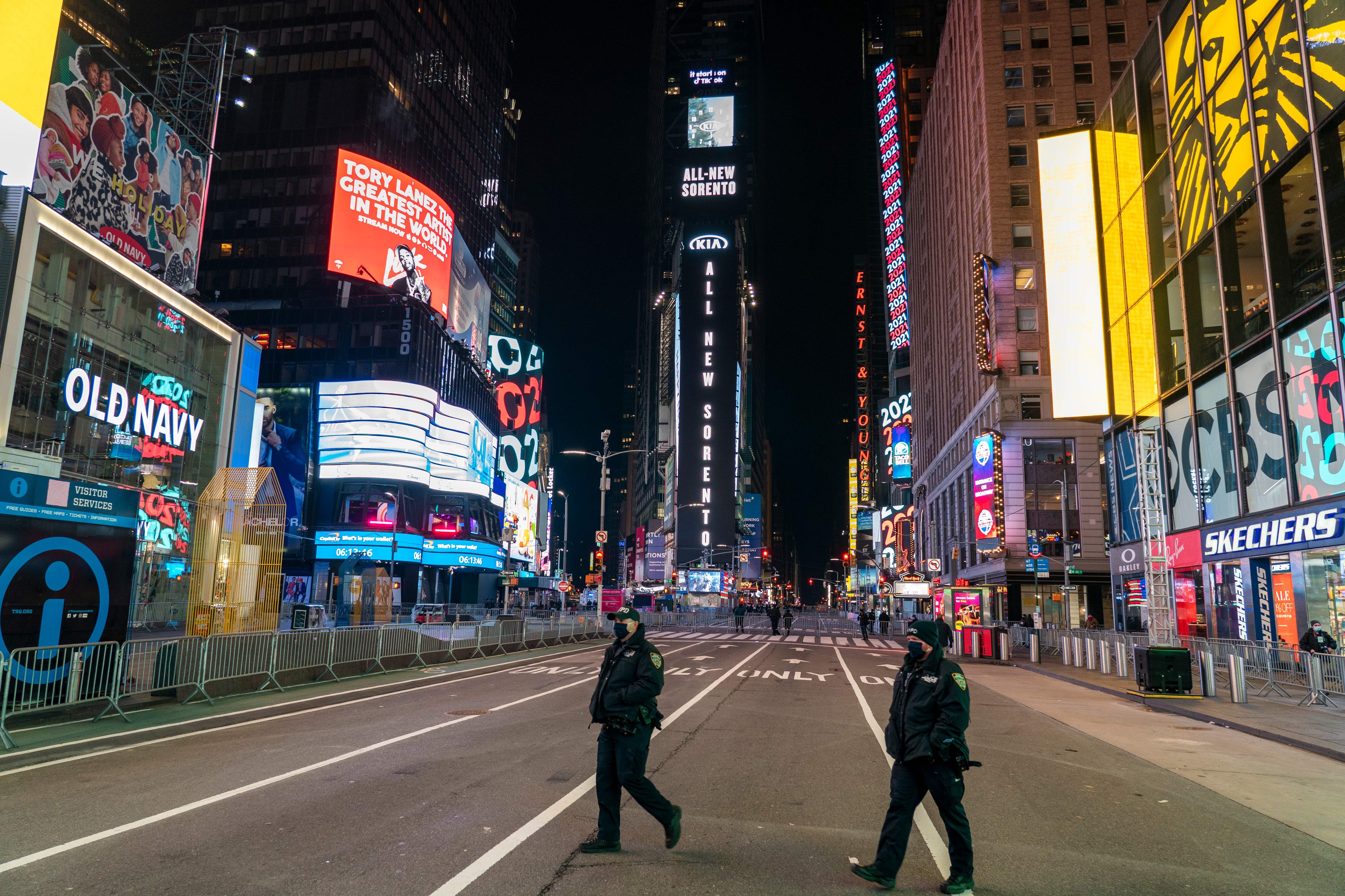 Police officers walk in a nearly empty Times Square due to Covid-19 restrictions on New Year's Eve in New York City, December 31, 2020.