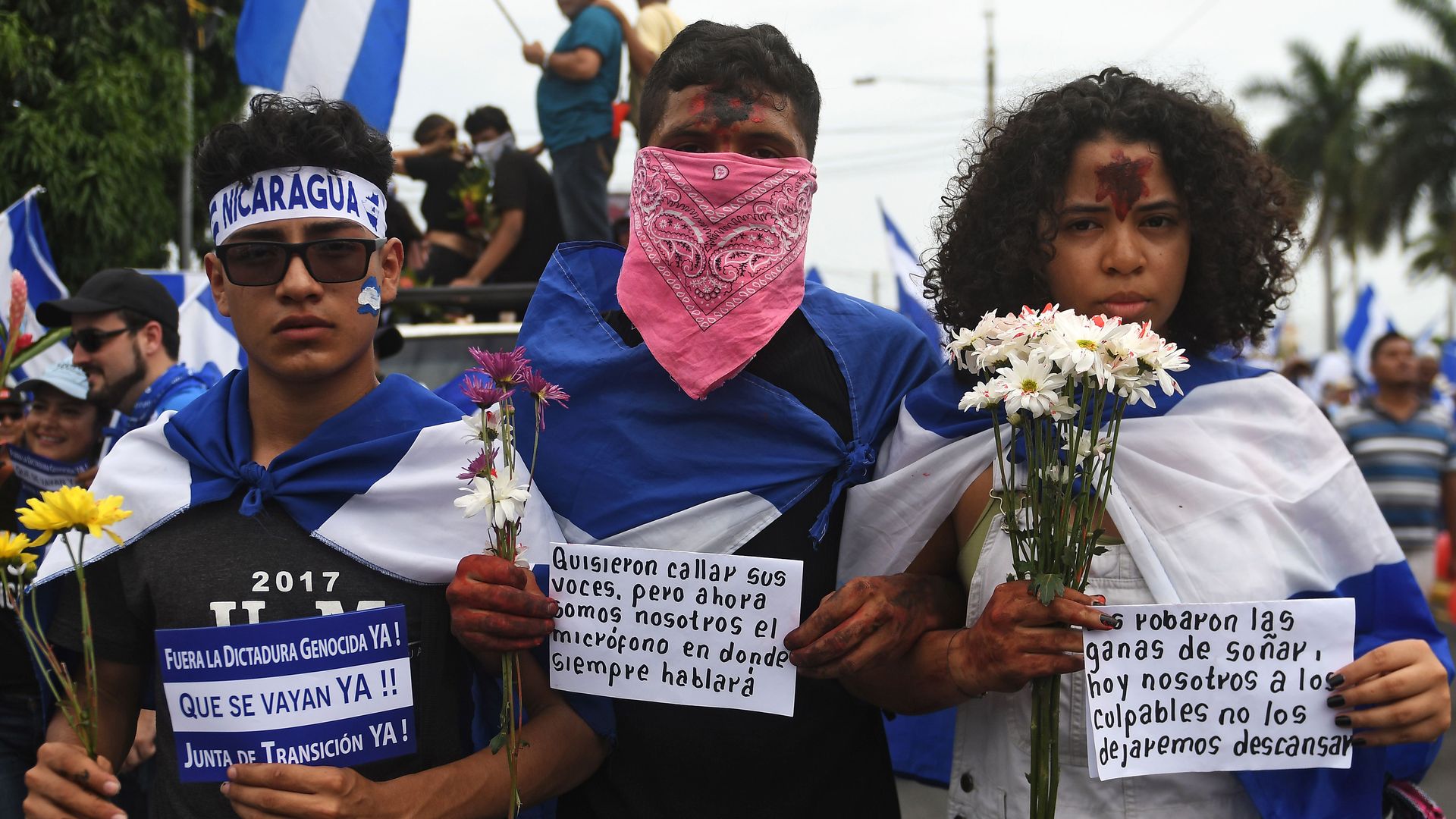 People attend the 'Marcha de las Flores'  in honor of children killed during protests in Managua on June 30, 2018.