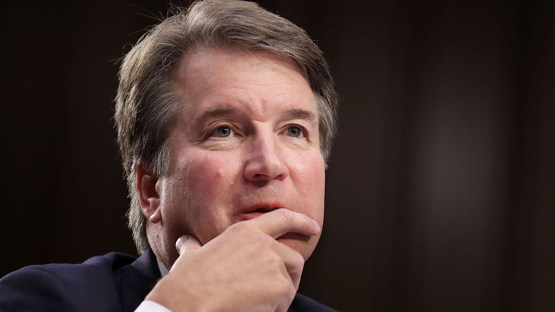 Brett Kavanaugh rests his chin on his hand while answering questions from the Senate Judiciary Committee.