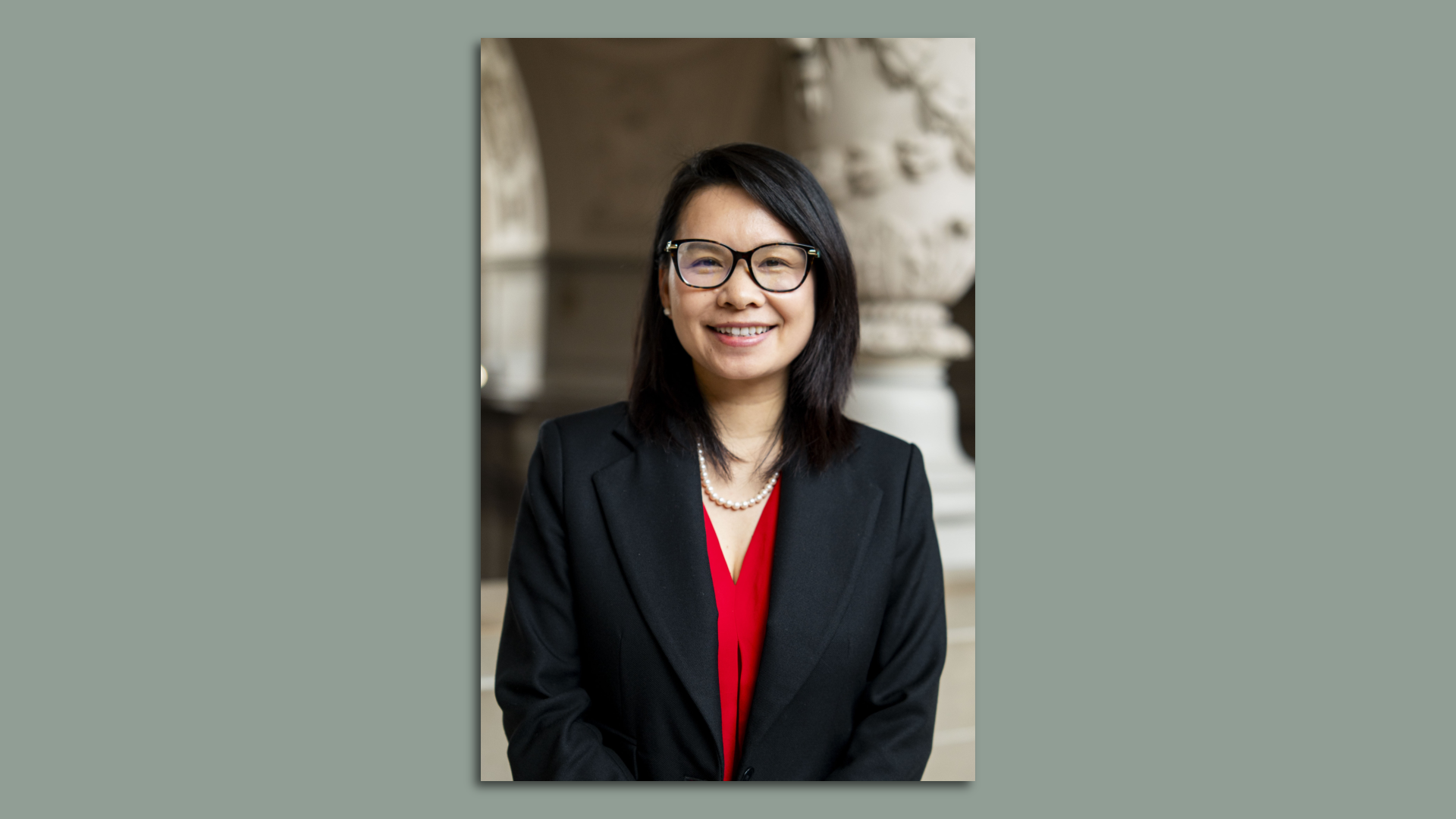 Photo of Chyanne Chen smiling at the camera in a red top and black blazer