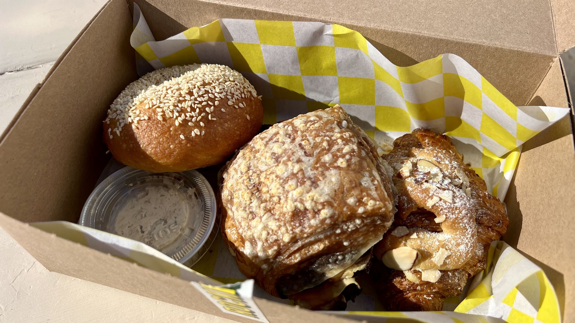 A photo of three baked goods in a box.