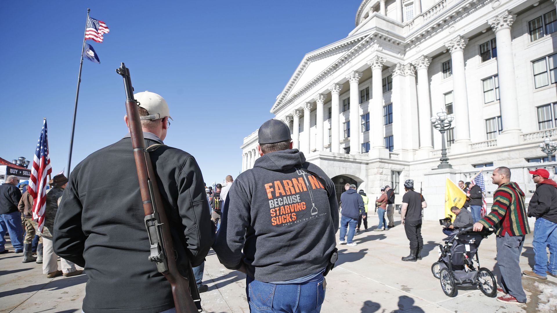  Two men with their firearms listen to speakers at a protest to new gun legislation at the Utah State Capitol in Salt Lake City, Utah on February 8, 2020. 