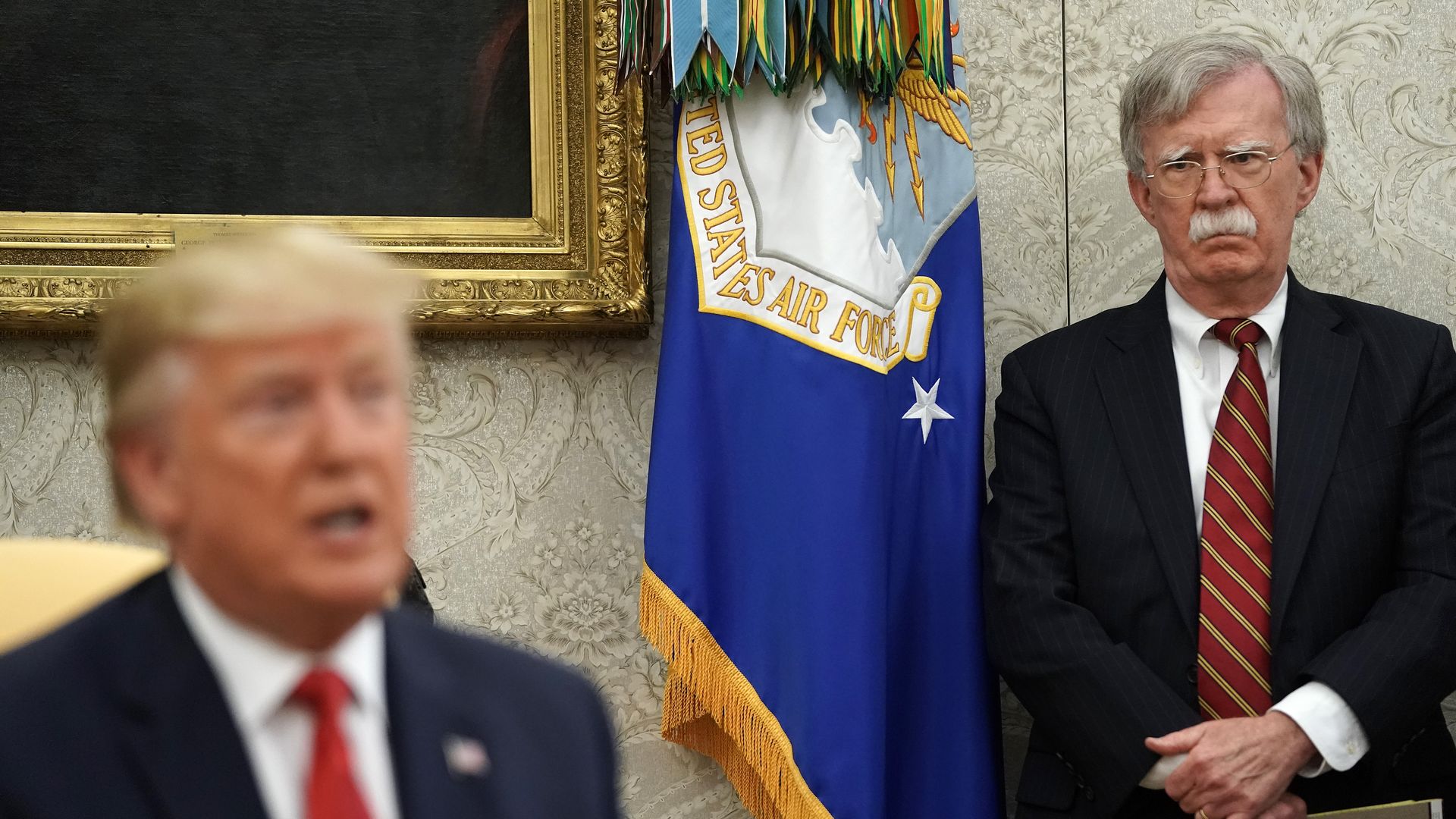 John Bolton watching Trump