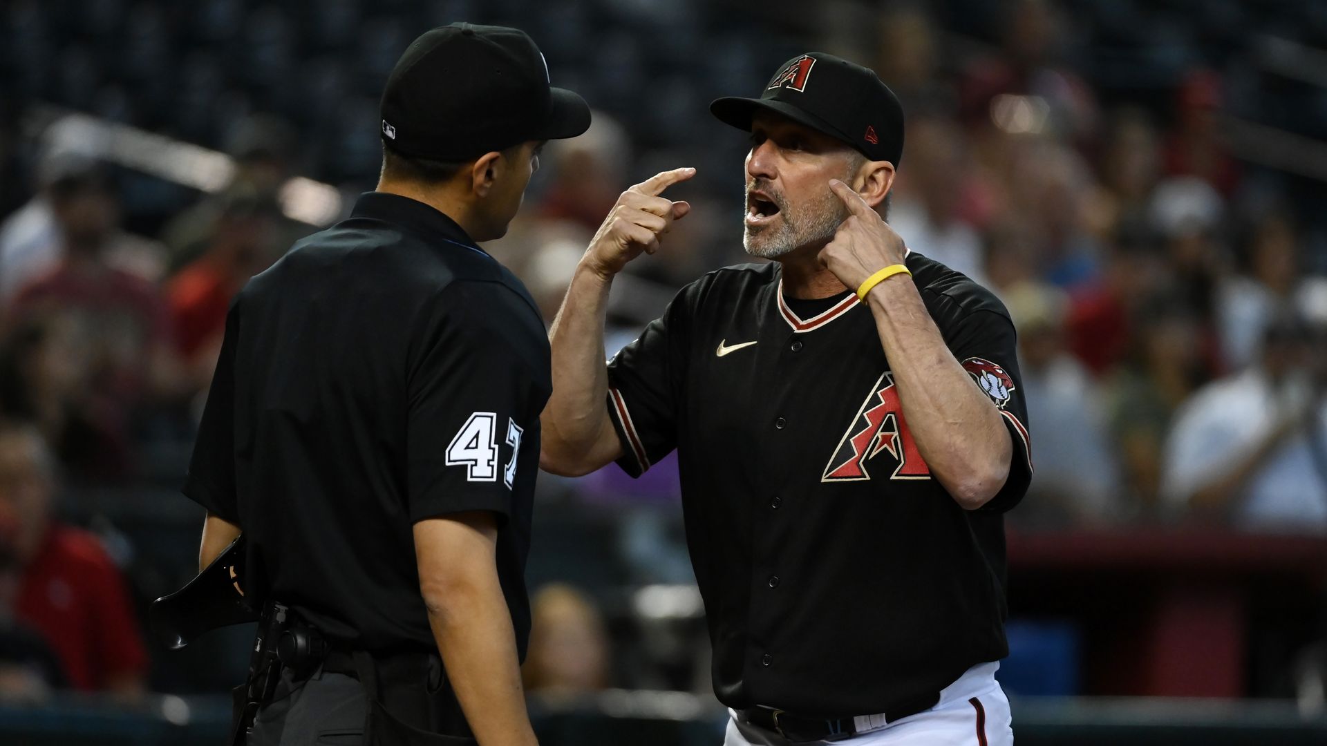 A baseball coach yelling at an umpire.