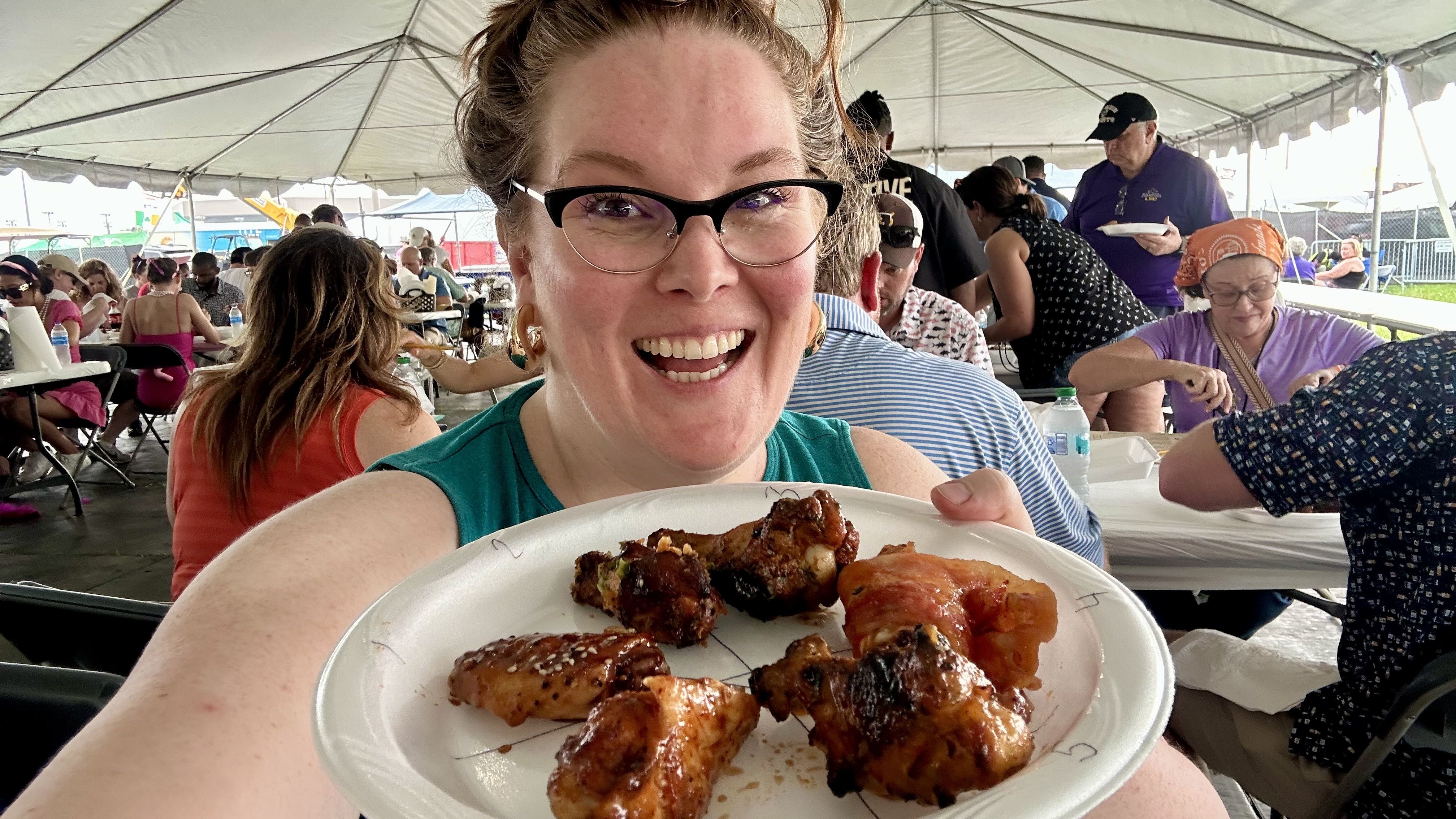 Image shows Carlie eating wings
