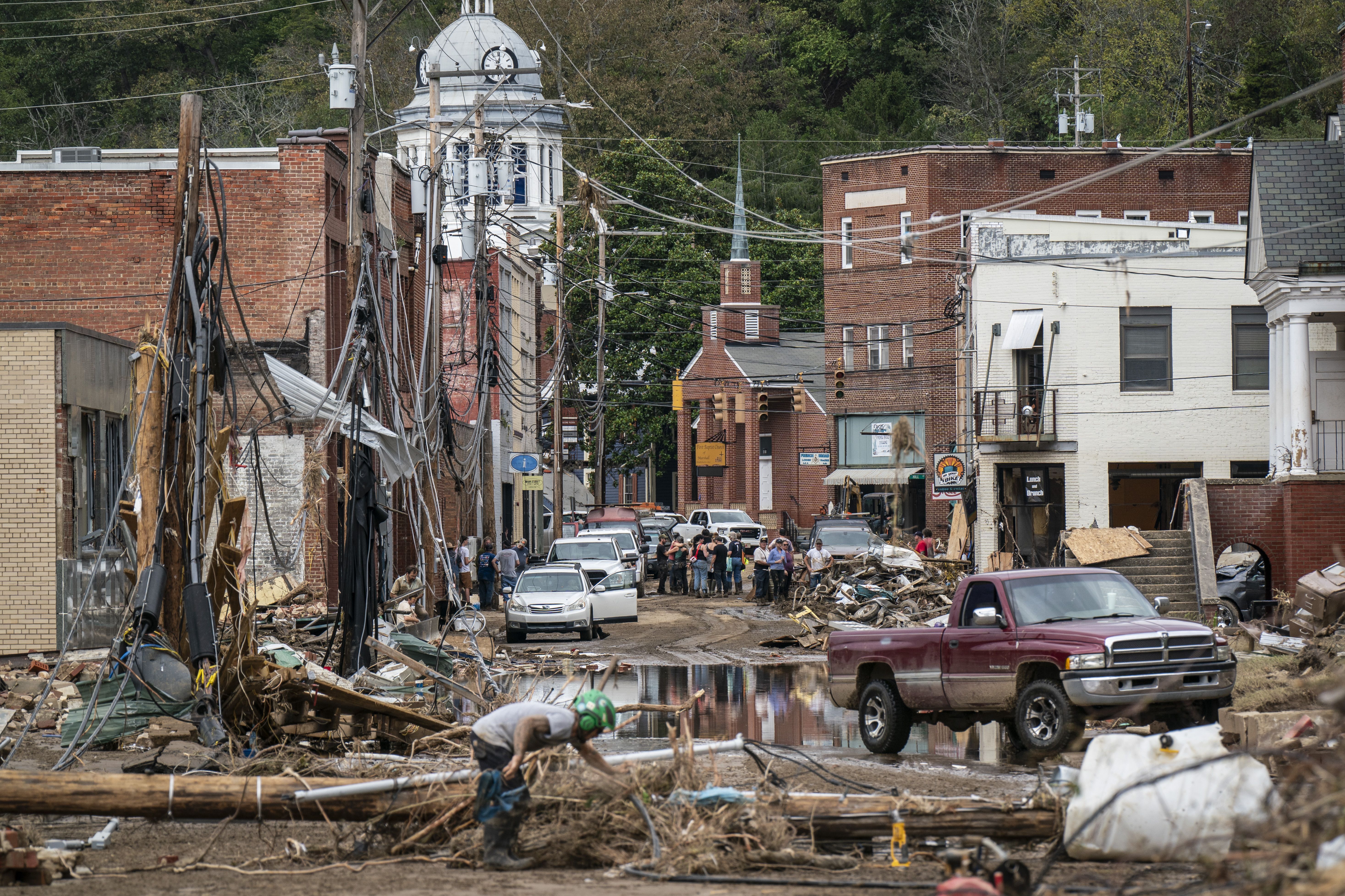 Marshall, NC - September 30 : Workers, community members, and business owners clean up debris in the aftermath of Hurricane Helene in Marshall, North Carolina on Monday, Sept. 30, 2024. (Photo by Jabin Botsford/The Washington Post via Getty Images)
