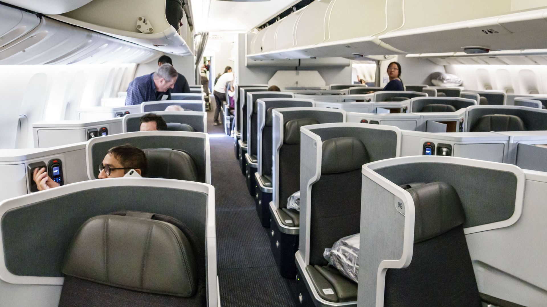 Travelers in business class of an American Airlines flight.