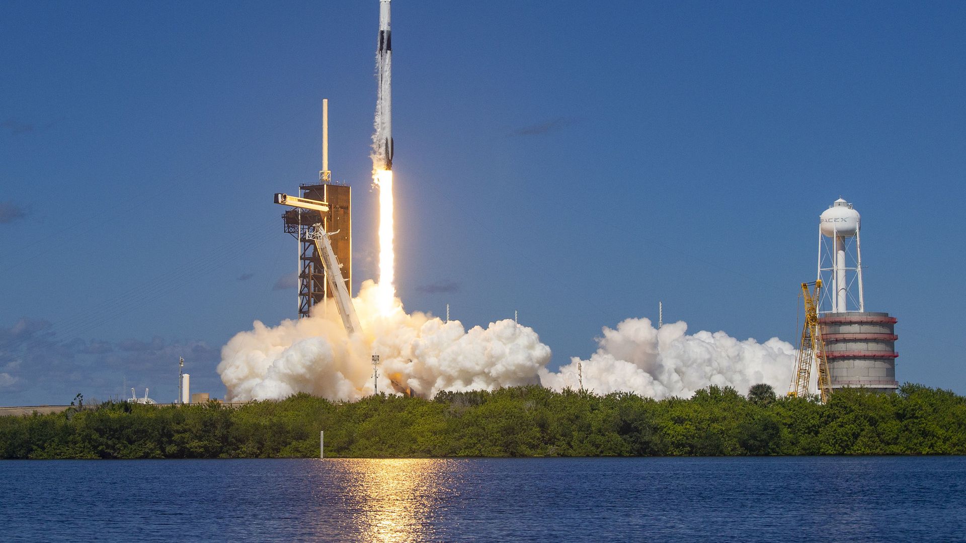A Falcon 9 rocket launching into a blue sky in Florida