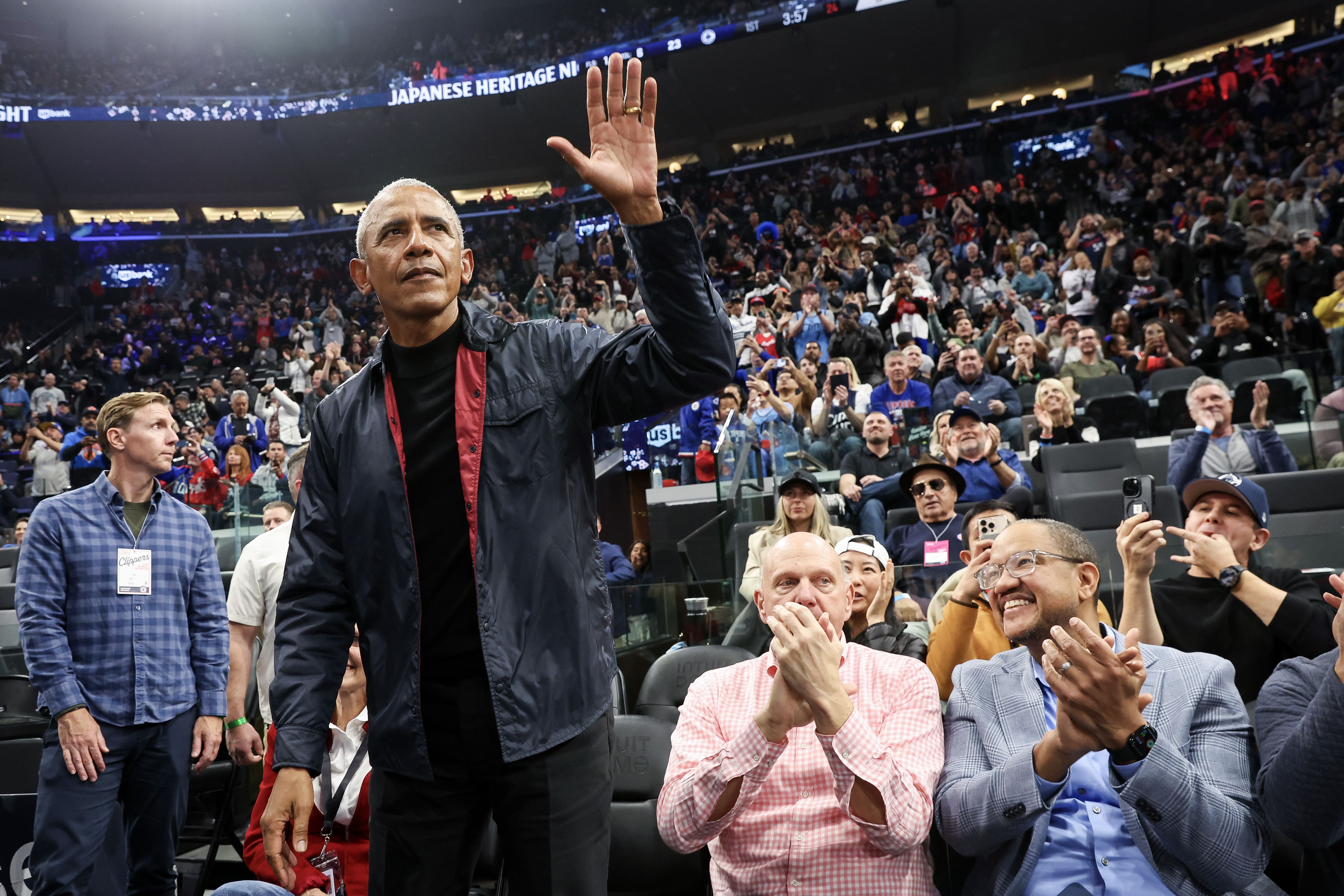 Former President Obama waves to fans at a Los Angeles Clippers game in March.