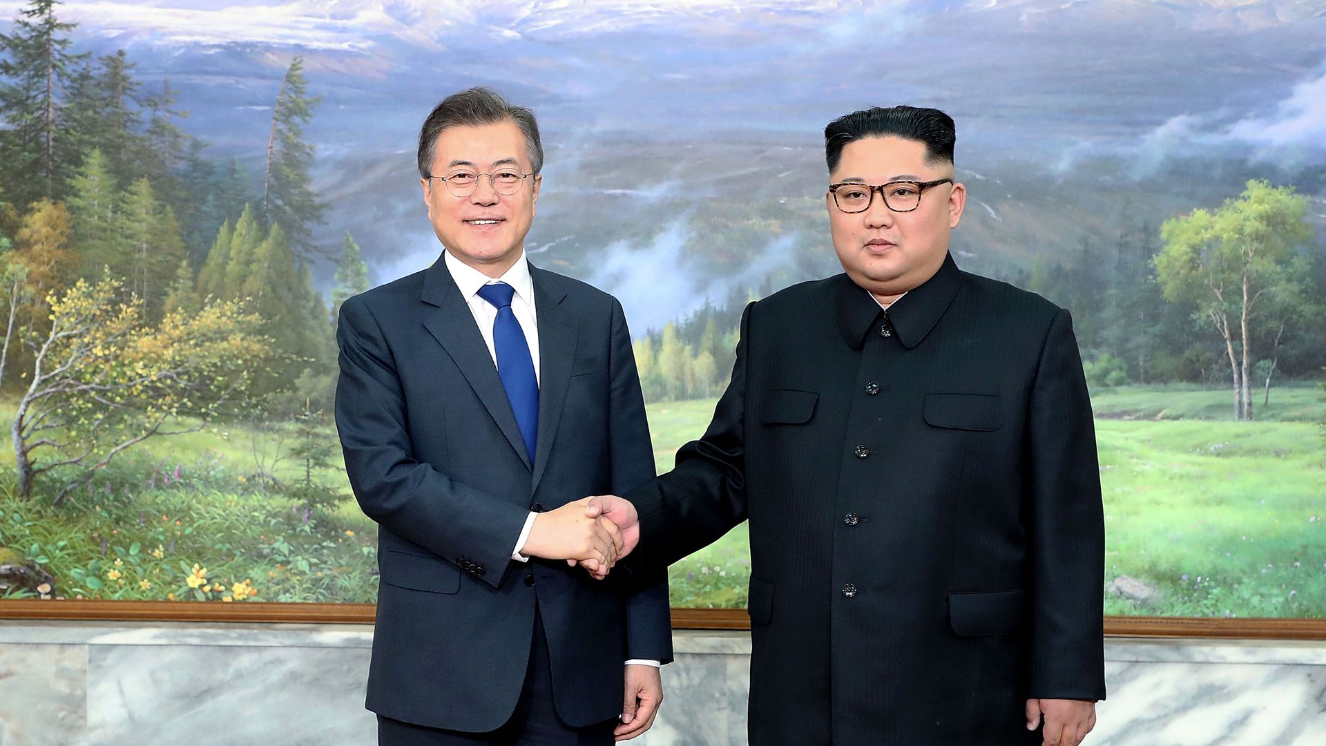 Moon Jae-in shaking hands with Kim Jong Un