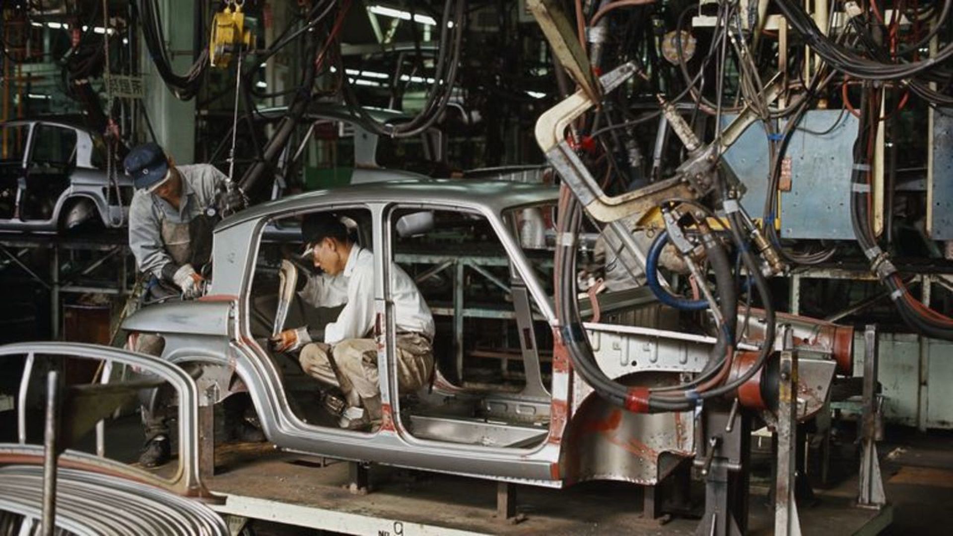 Factory workers assembling a car. Photo: Jerry Cooke/Corbis via Getty Images