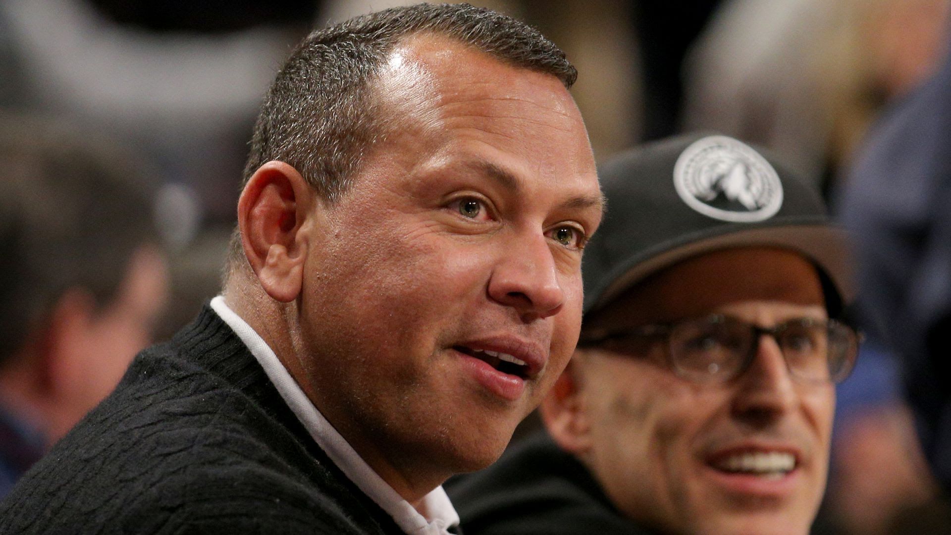 Alex Rodriguez smiles at a Timberwolves game. 