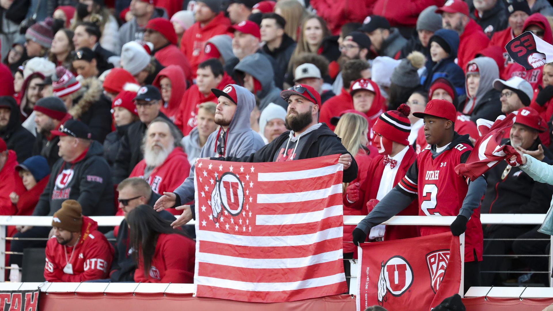 A crowd of University of Utah football fans watches a game.