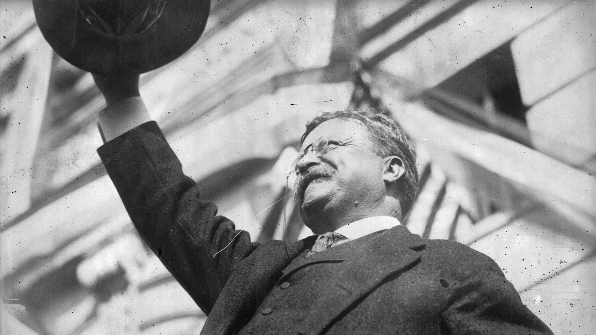 President Teddy Roosevelt waves his hat.