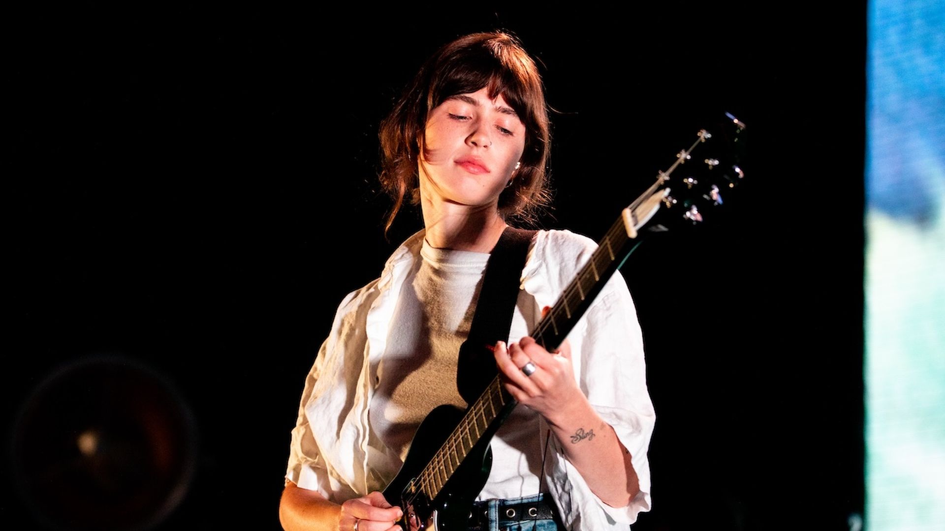 A photo of a person playing guitar.