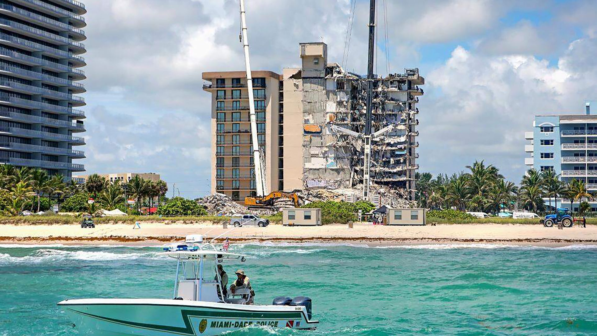The Miami-Dade Marine Patrol Unit navigates as search and rescue personnel search for survivors through the rubble at the Champlain Towers South Condo in Surfside, Florida, Sunday, June 27, 2021. The apartment building partially collapsed on Thursday, June 24. (David Santiago/Miami Herald/Tribune Ne