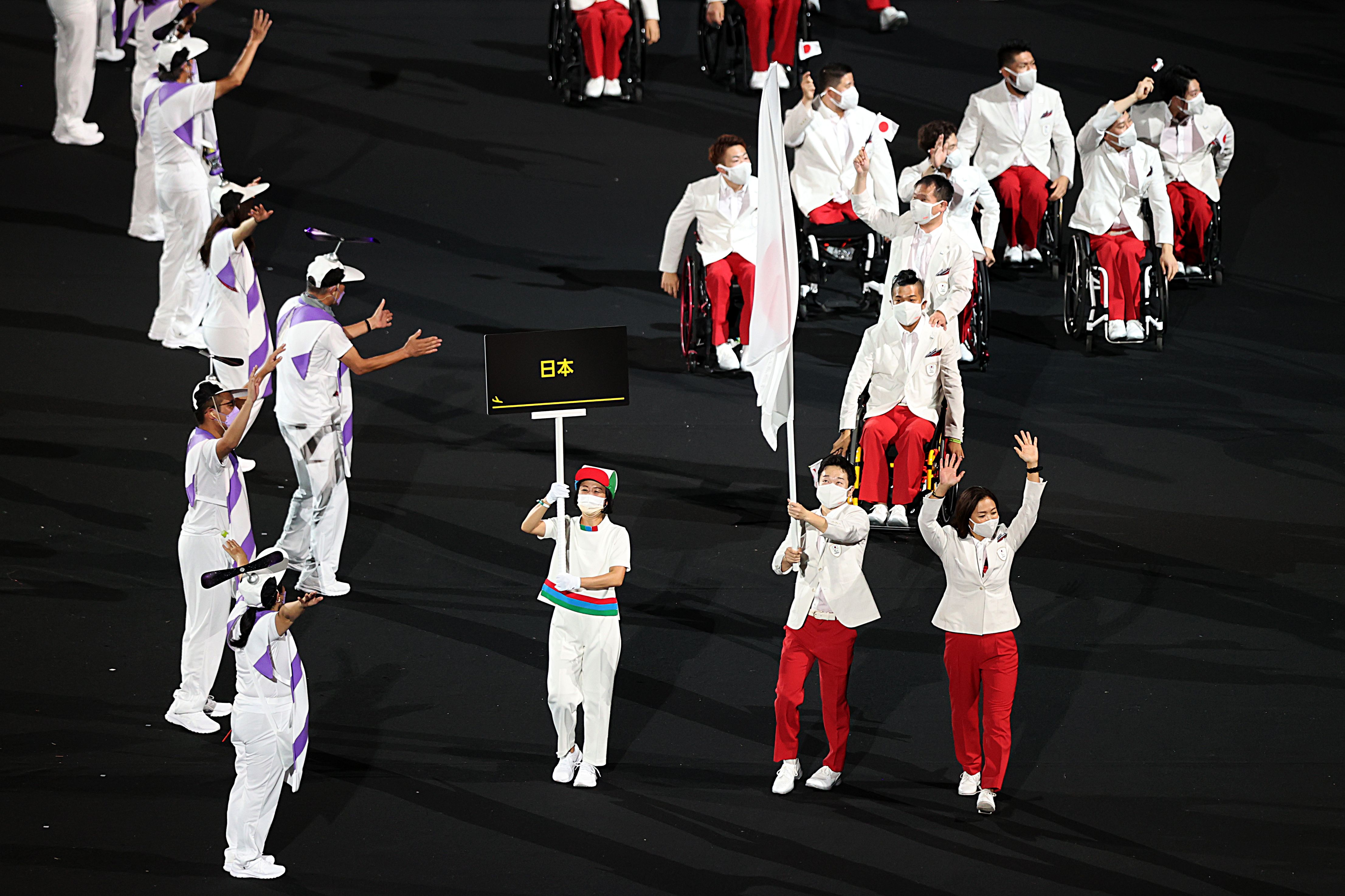 Flag bearers Mami Tani and Koyo Iwabuchi of Team Japan lead their delegation in the parade of athletes. Photo: Naomi Baker/Getty Images