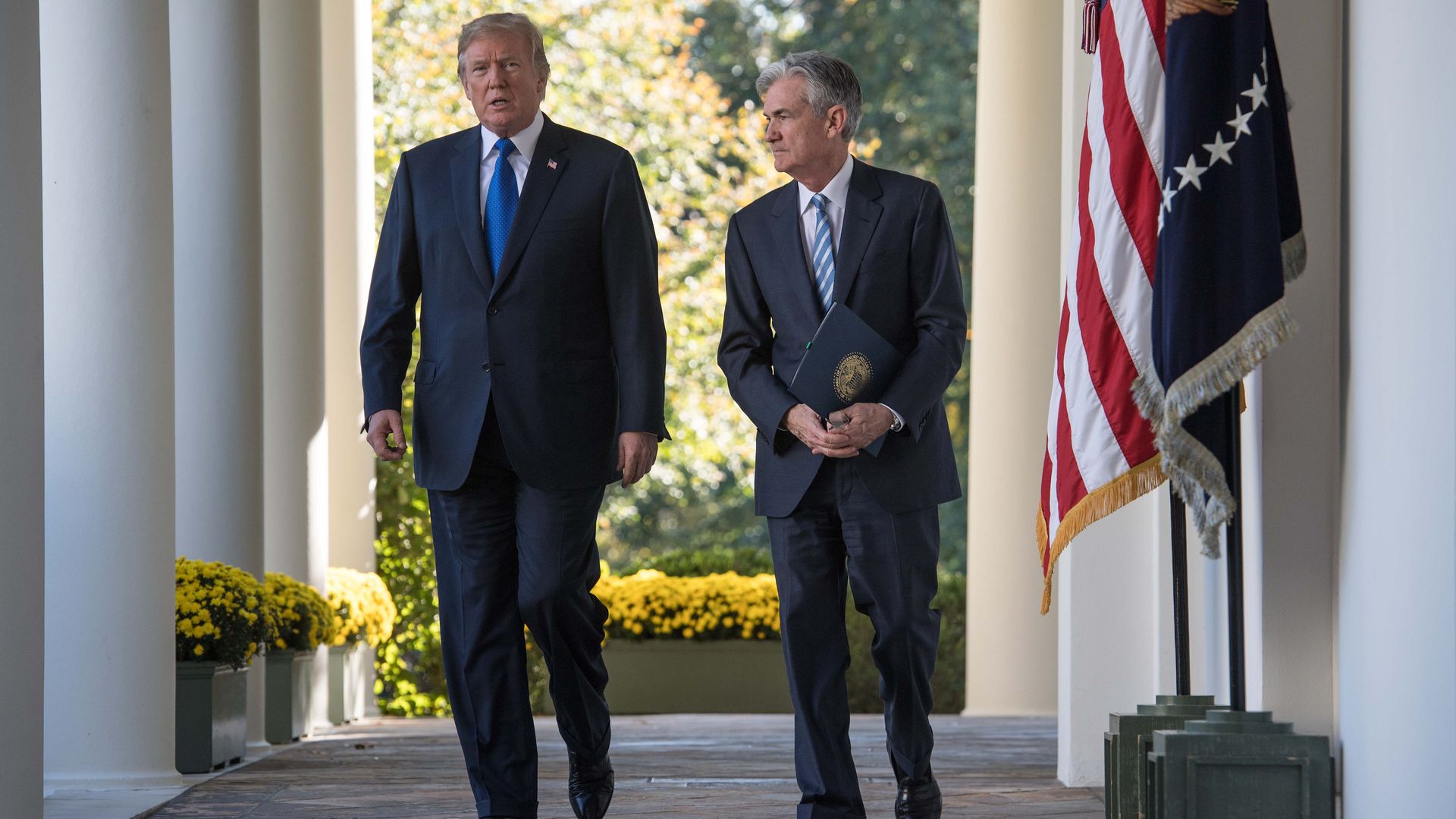 President Donald Trump and Fed Chairman Jerome Powell walk together.