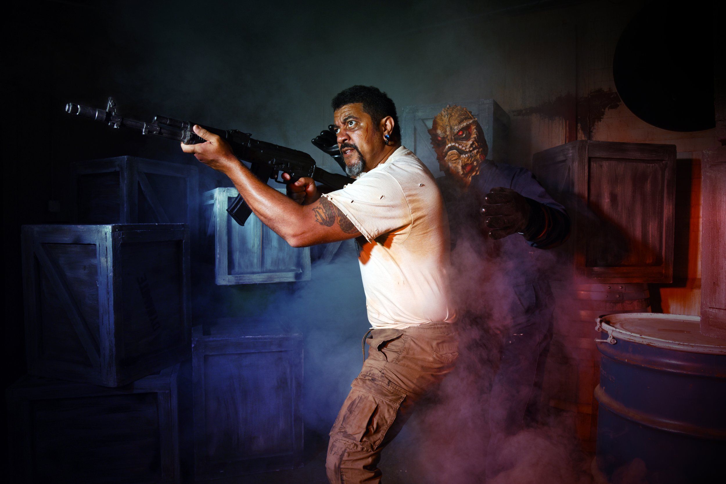 Photo of a person with a gun and an alien behind them 