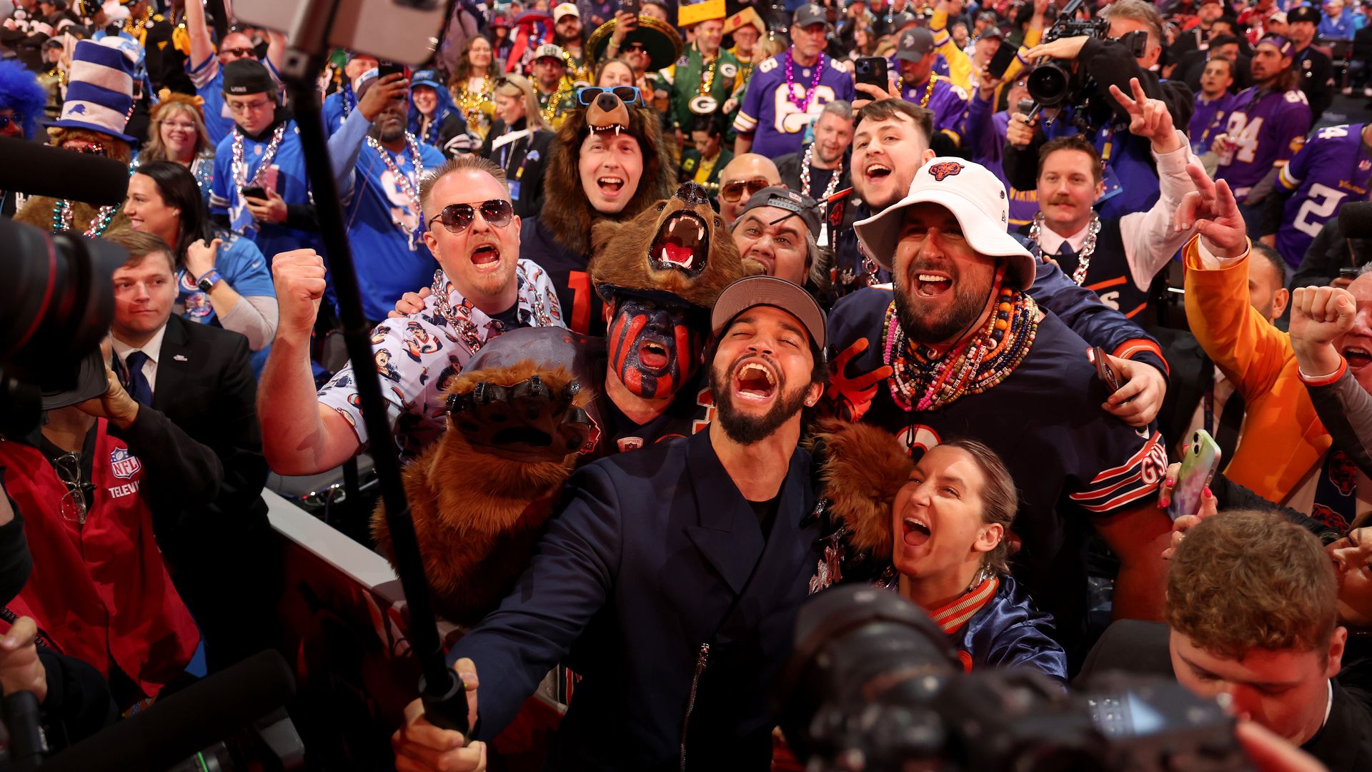 Caleb Williams celebrates with fans after being selected first overall by the Chicago Bears during the first round of the 2024 NFL Draft at Campus Martius Park and Hart Plaza on April 25, 2024 in Detroit, Michigan.