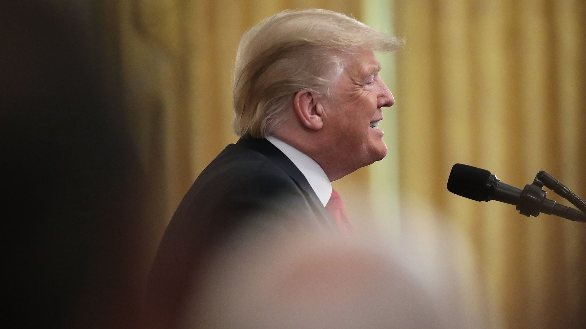 Donald Trump talking at a podium. 