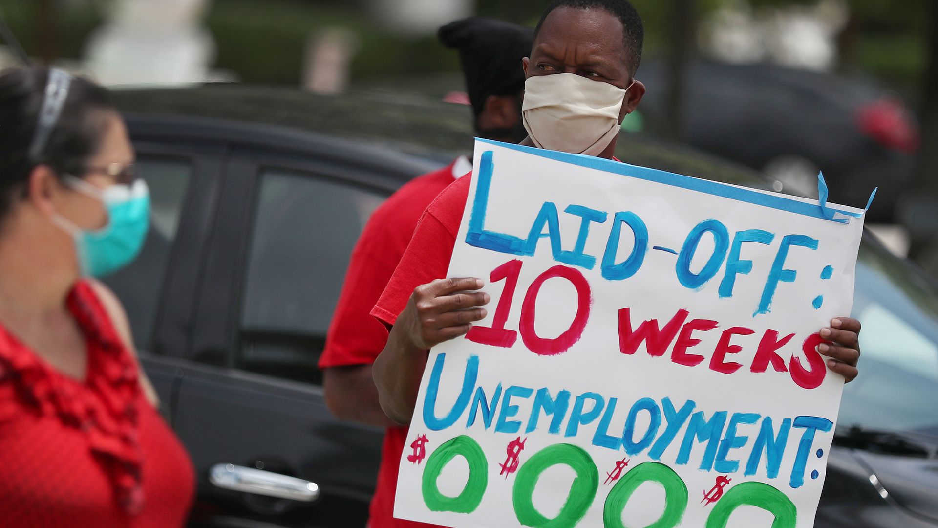 Protester holding a sign asking the state of Florida to fix its unemployment system on May 22, 2020 in Miami Beach, Florida