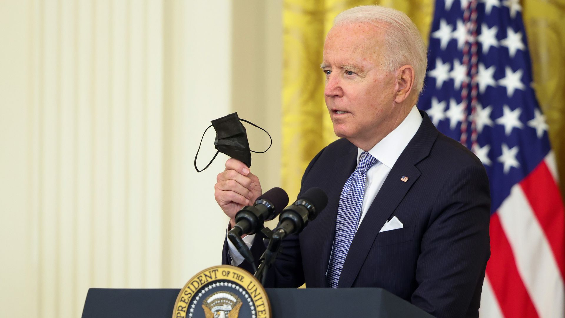 President Biden is seen waving a mask last week.