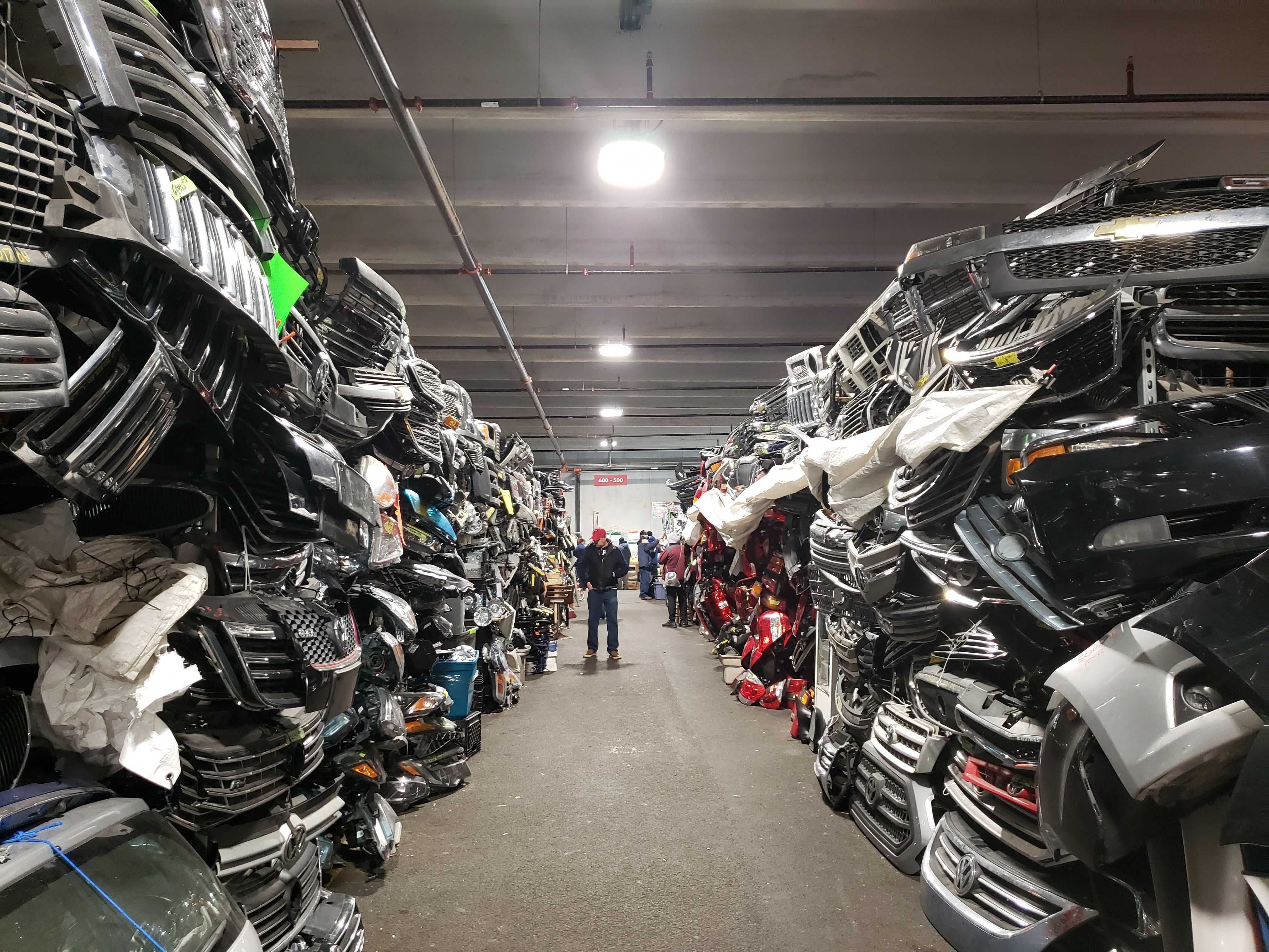 Phot of a long aisle full of car parts and bumpers.