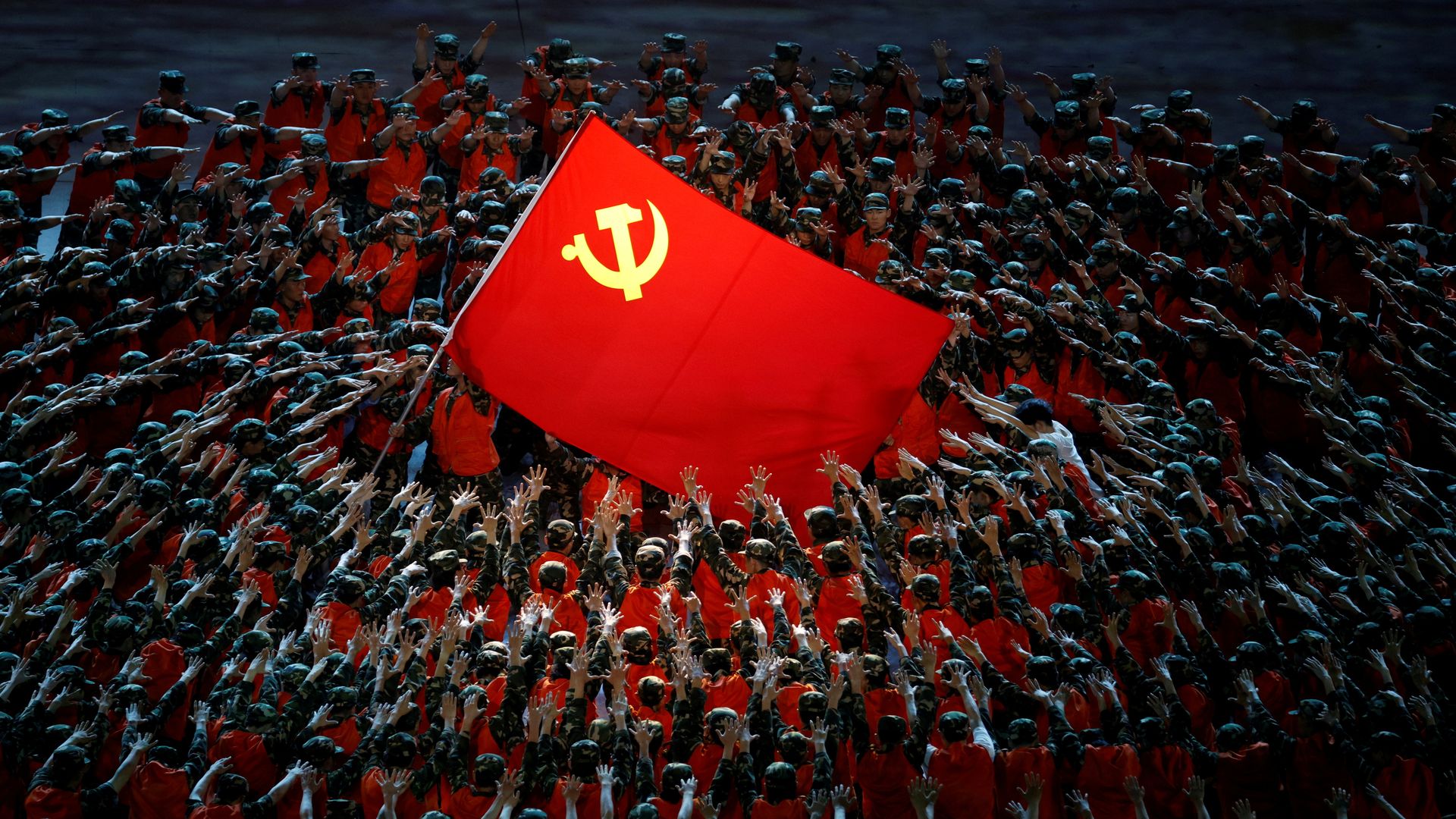 Performers rally around the Red Flag during a show commemorating the 100th anniversary of the founding of the Communist Party of China at the National Stadium in Beijing