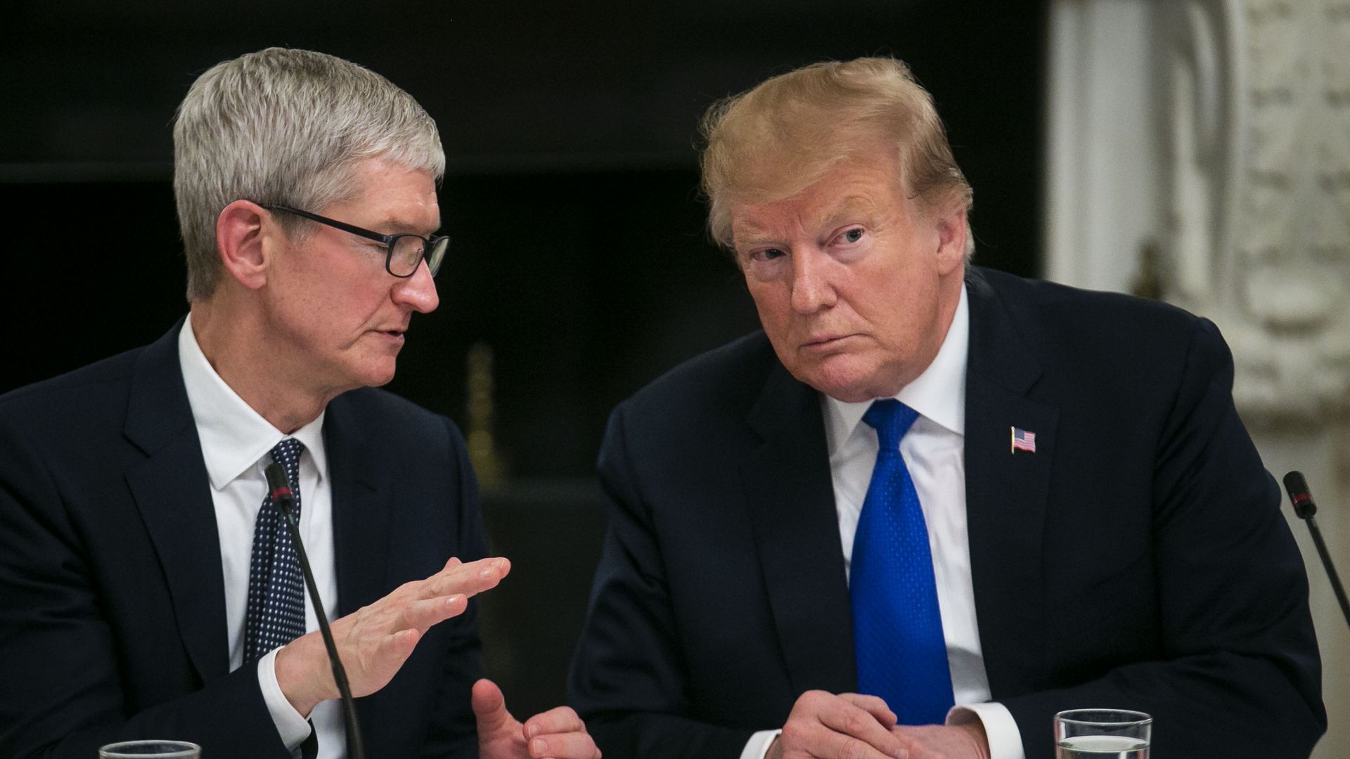 Apple CEO Tim Cook speaks to President Trump at the White House in 2019.