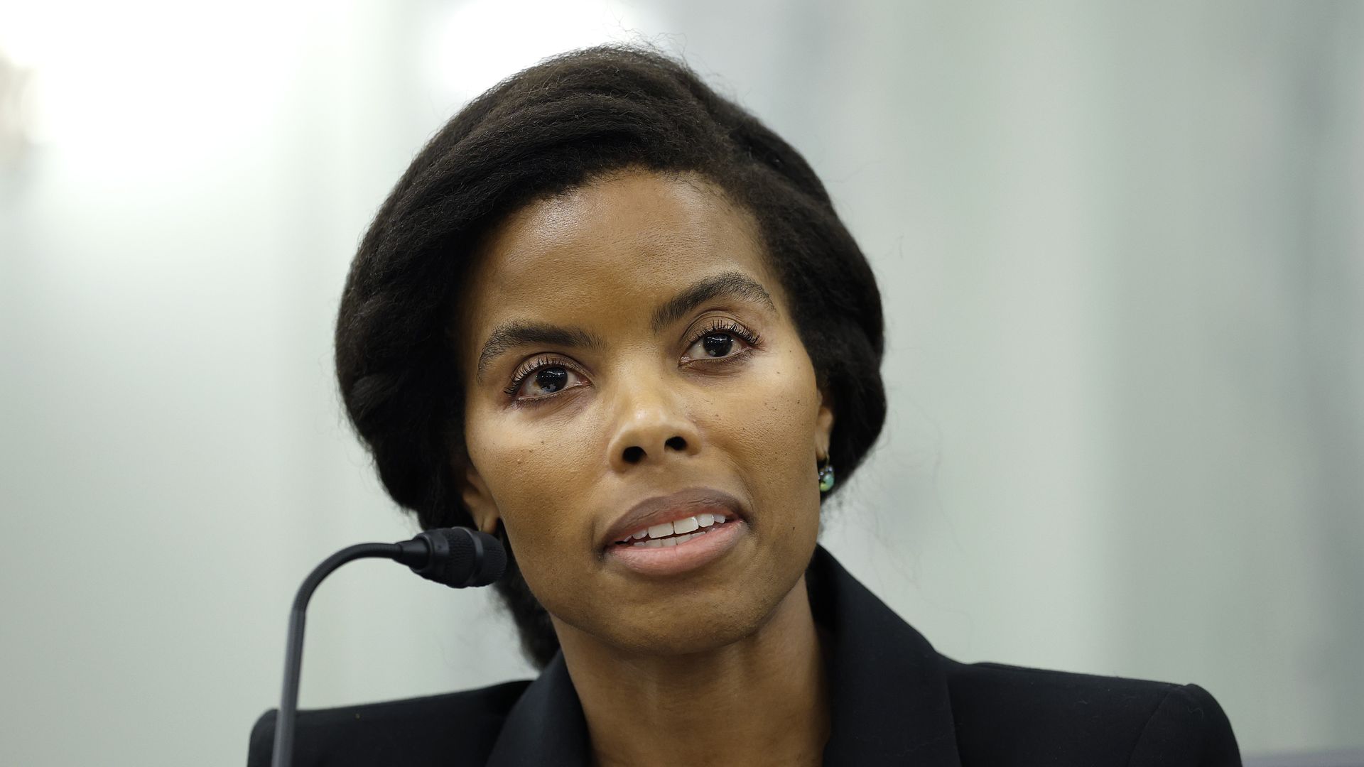 A person sits in front of a microphone