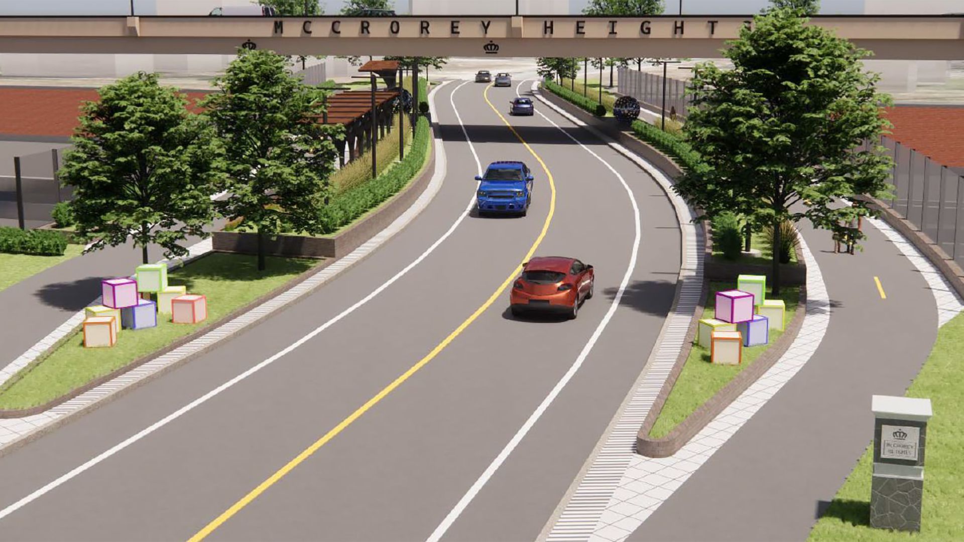 City street under an arch reading "McCorey Height". A curved two-lane road with a yellow center line, sidewalks, trees, and colorful cube planters; several cars drive ahead.