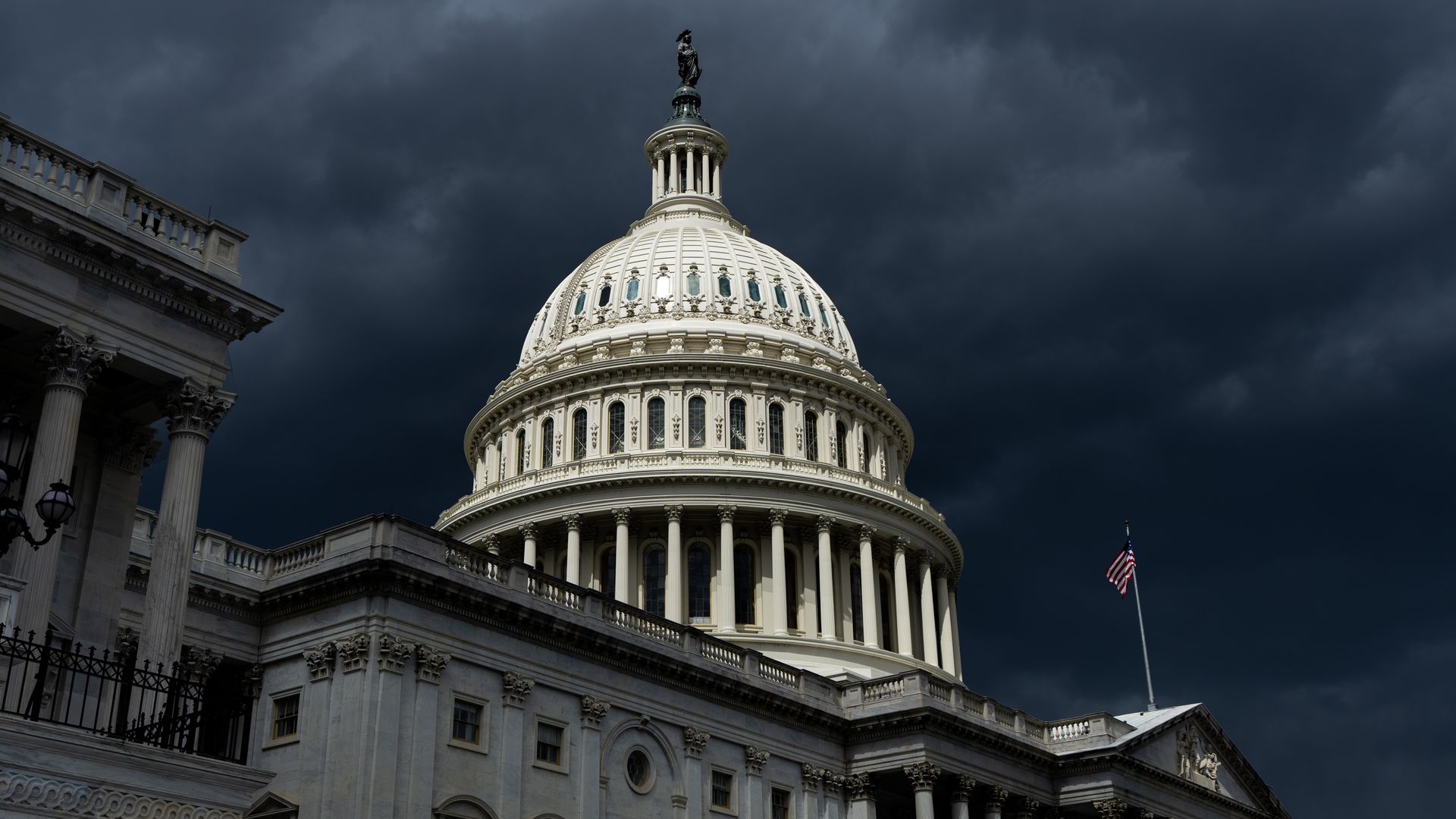 An image of the U.S. Capitol dome surrounded by storm clouds