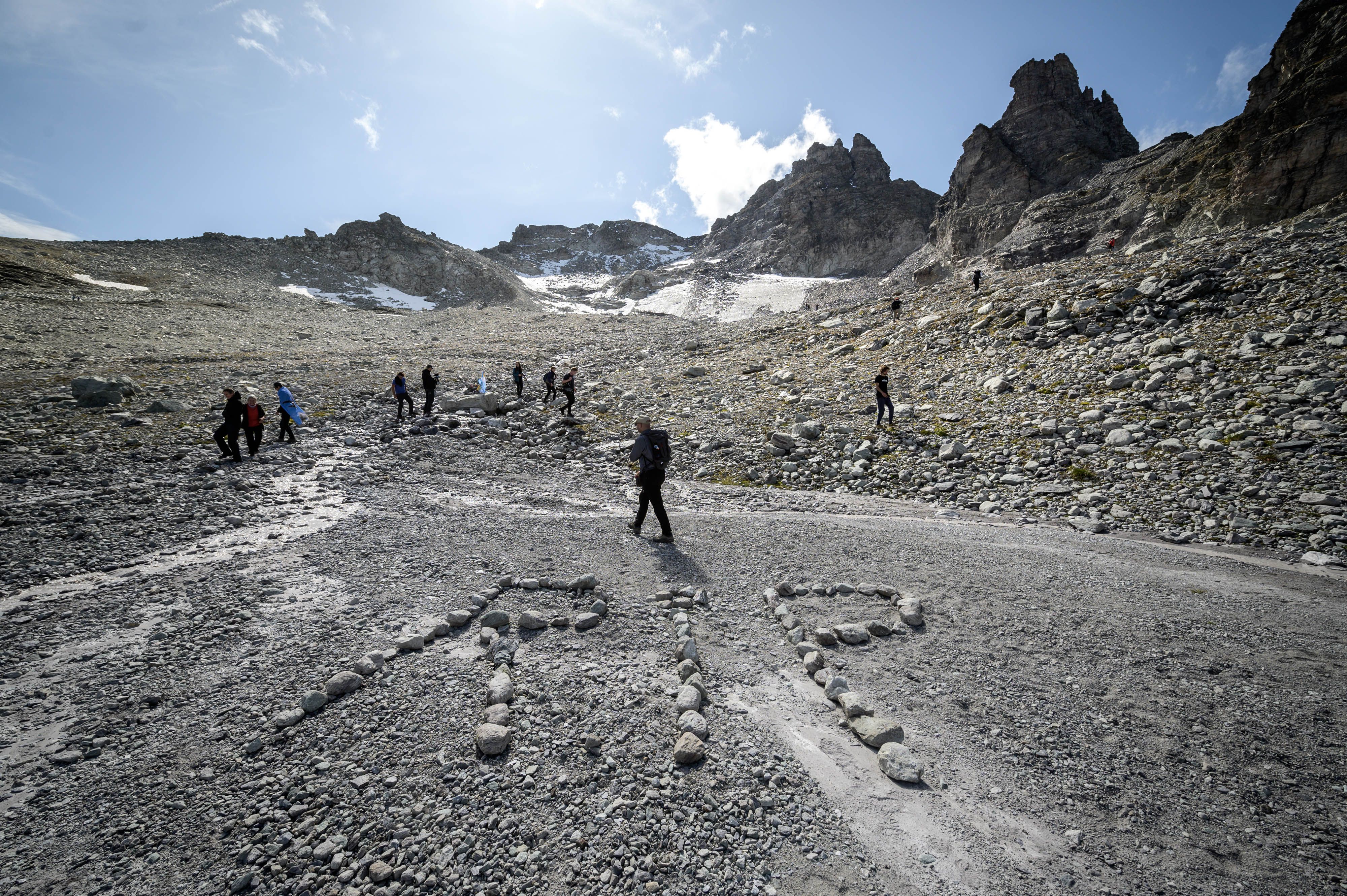  People take part in a ceremony to mark the 'death' of the Pizol glacier (Pizolgletscher) on September 22, 2019 above Mels, eastern Switzerland. 