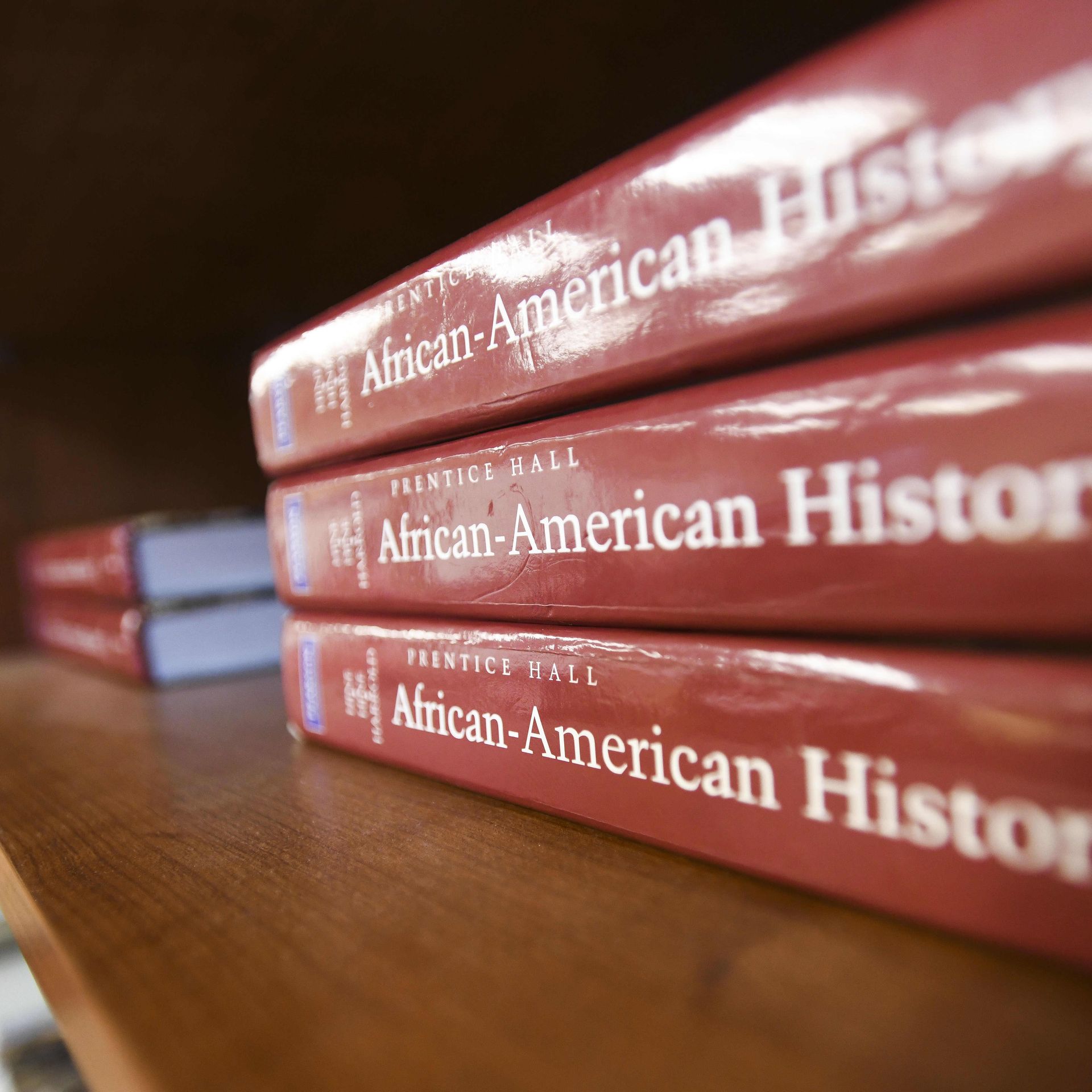 Photo of three red textbooks with the words "African-American History" printed on the binding. They are stacked on top of each other.
