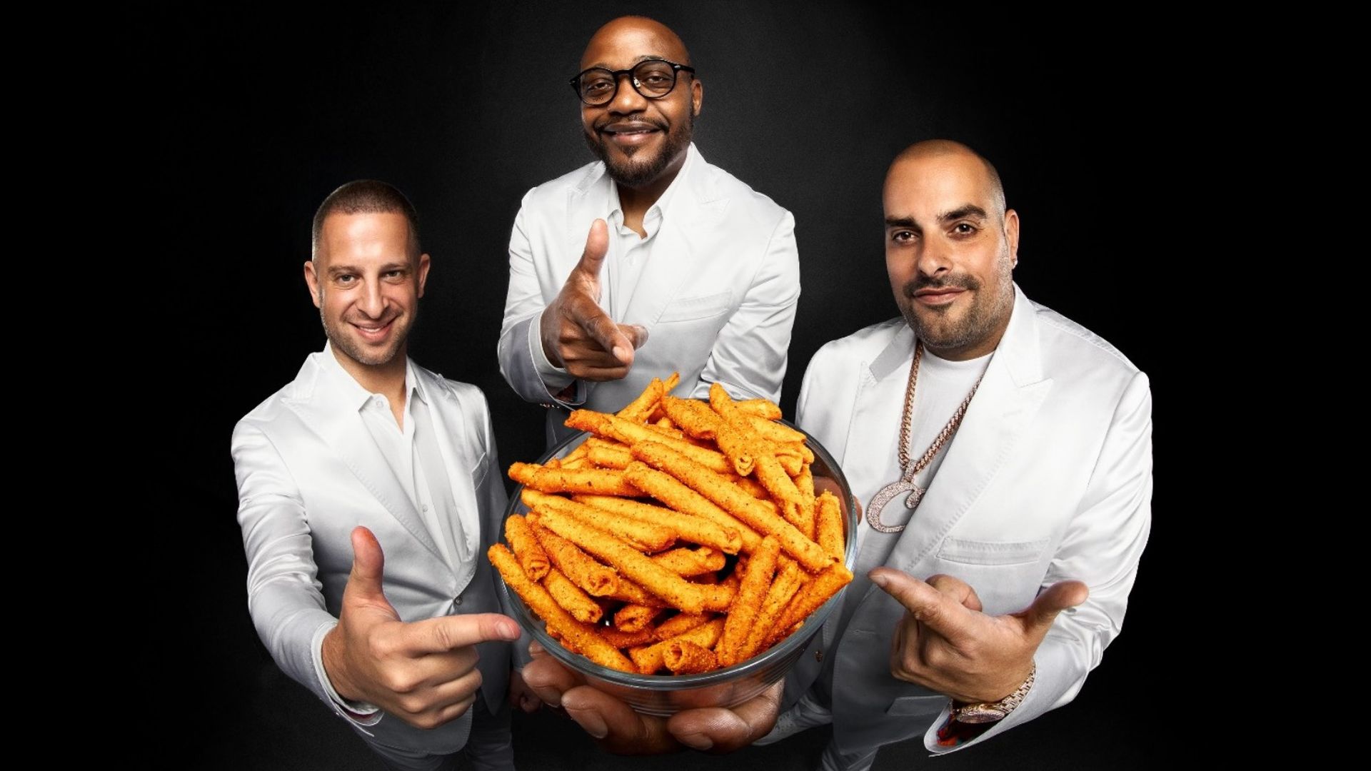 Photo: Chipoys co-founder Michael Berro, Rap Snacks founder James Lindsay and Cookies CEO Berner pose with Yikes! rolled tortilla chips. (Photo courtesy of Yikes!)