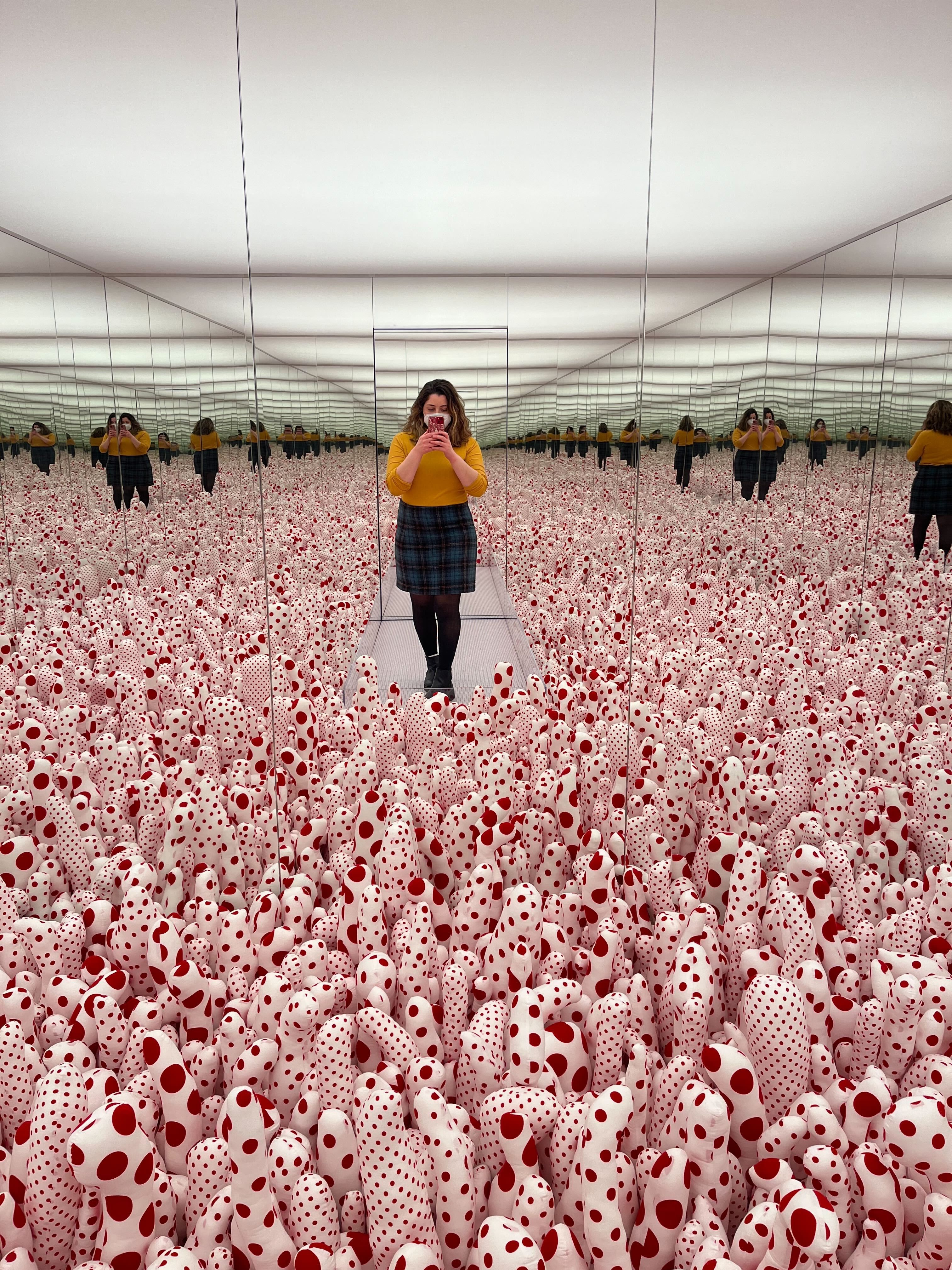 Chelsea Cirruzzo stands in the Phalli’s Field infinity mirror room.
