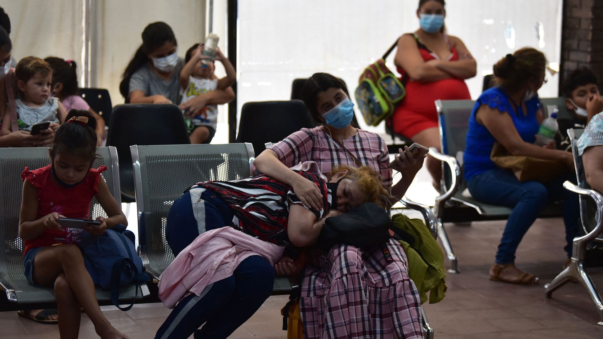 Several people sit on hospital chairs waiting to be seen in Paraguay, which is having an outbreak of the chikungunya virus. 