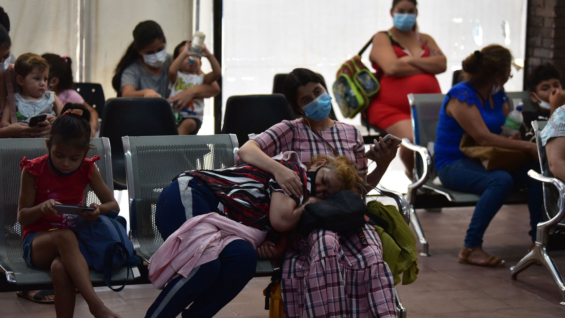 Several people sit on hospital chairs waiting to be seen in Paraguay, which is having an outbreak of the chikungunya virus.
