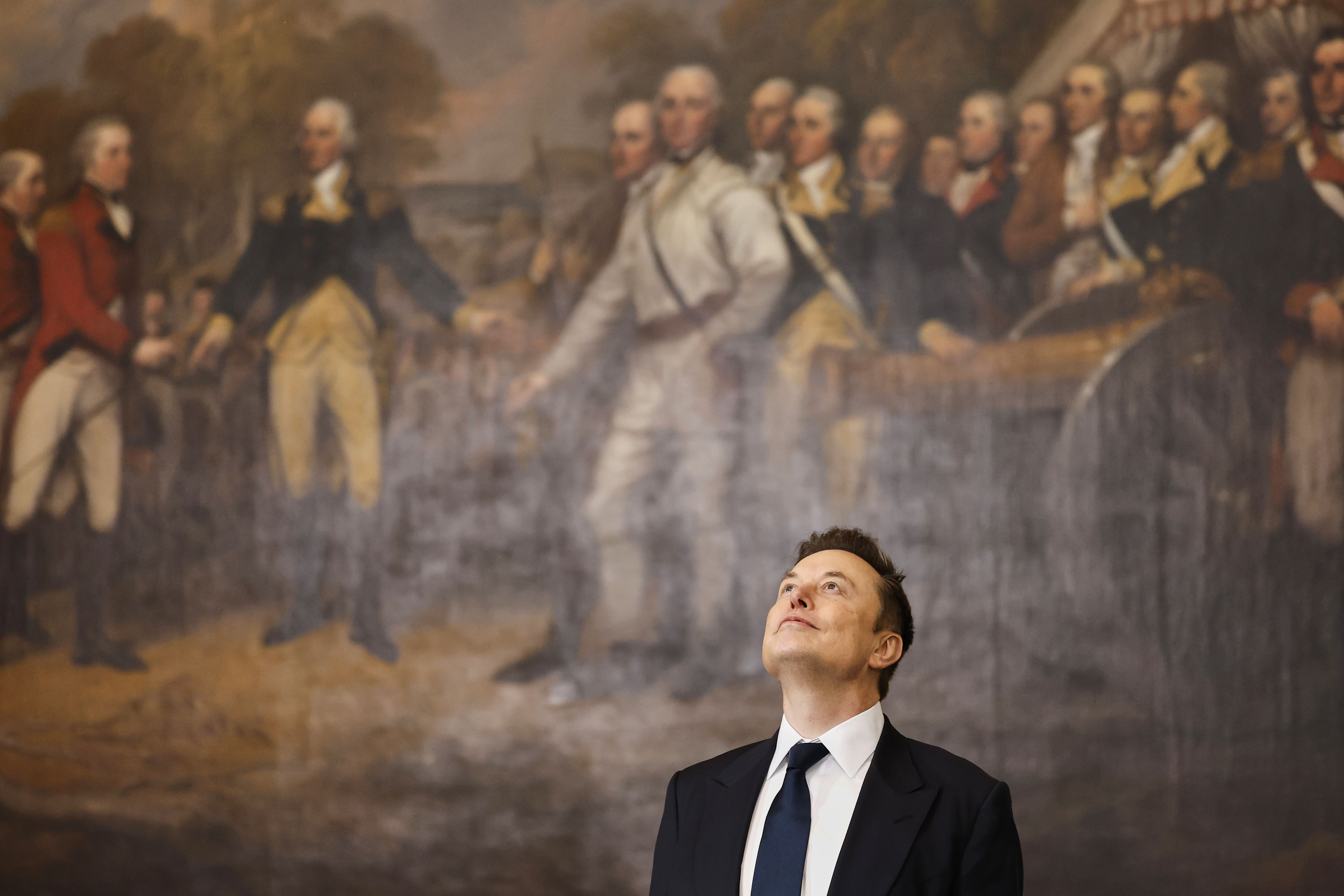 Elon Musk looks up at the inside of the Capitol Rotunda.