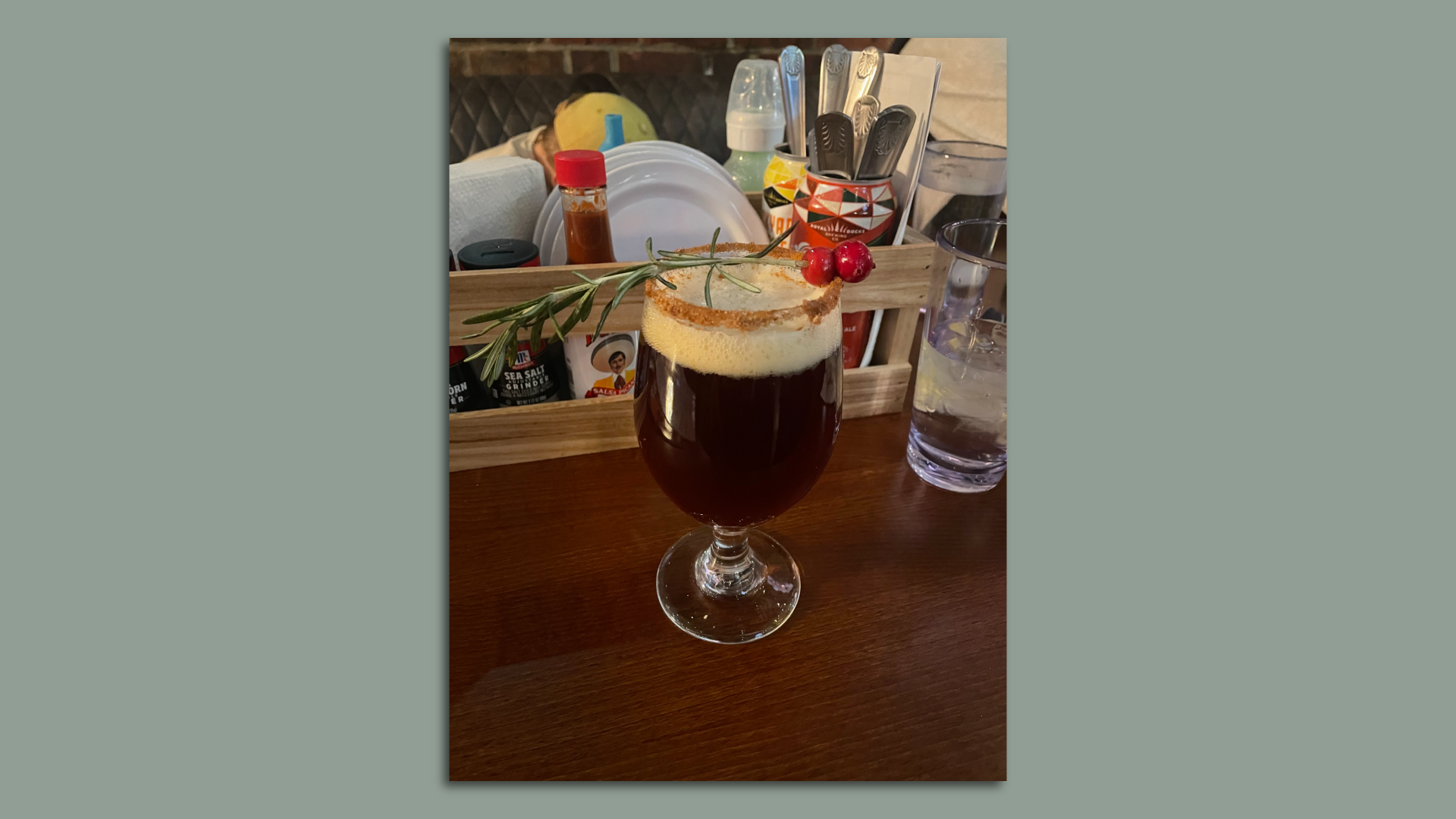 Photo of a goblet of holiday spiced ale with cinnamon rim and sprig