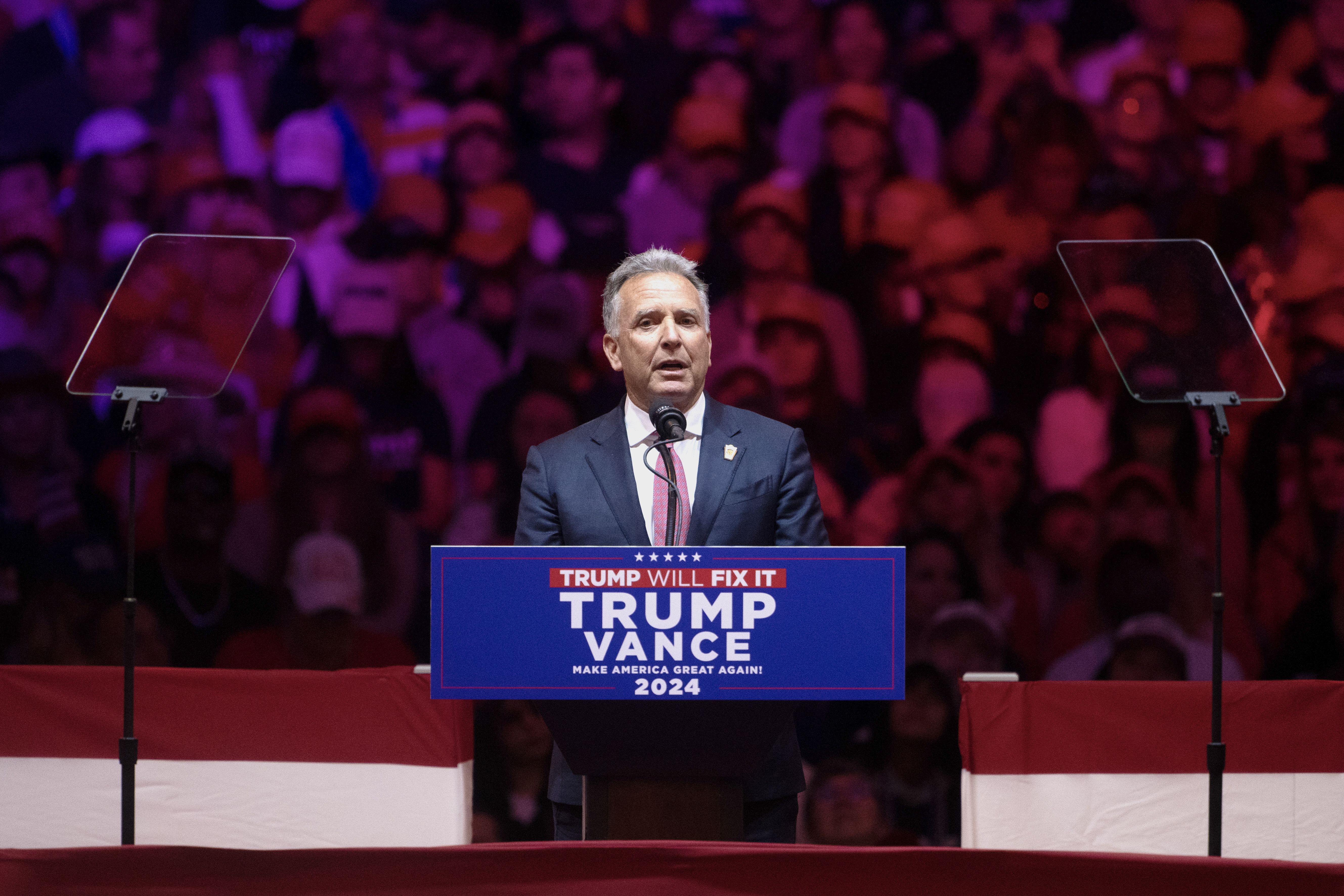 Witkoff behind a podium at a rally