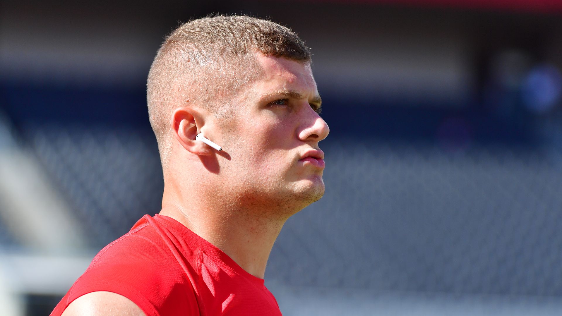 Photo of Carl Nassib in a red shirt looking into the air