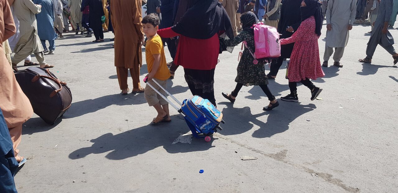 Afghans crowd at the tarmac of the Kabul airport on August 16, 2021, to flee the country as the Taliban were in control of Afghanistan
